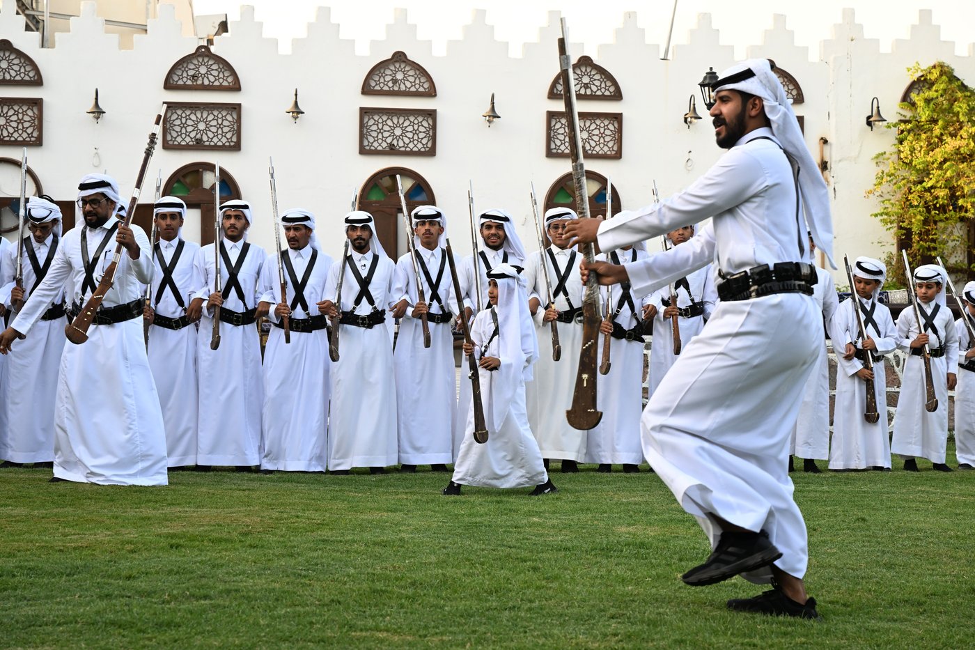 Al-Dara traditional Hejazi folk art with men in white thobes performing with rifles in Saudi Arabia