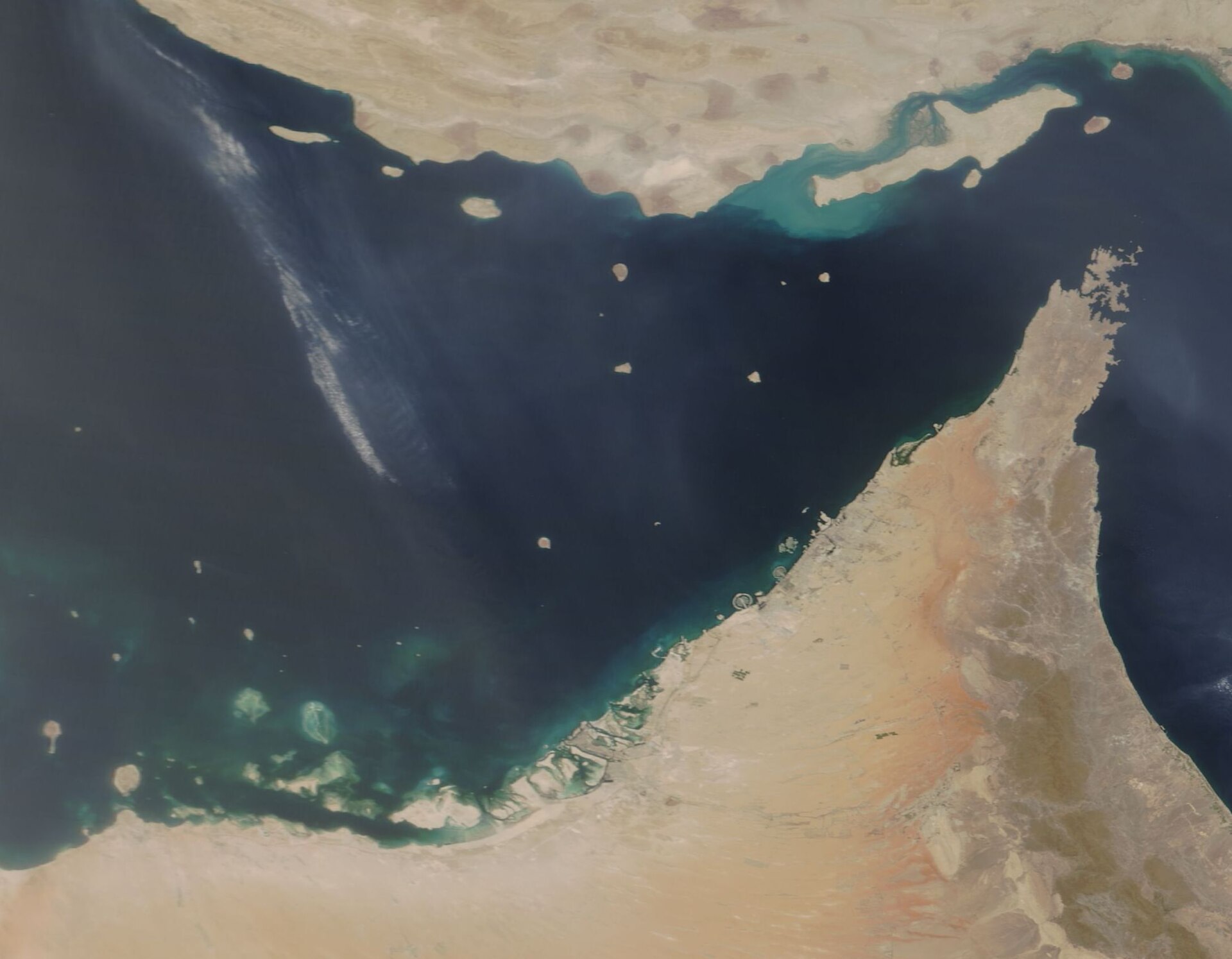 NASA MODIS satellite image of the Strait of Hormuz and UAE coastline, June 2018, showing the narrow passage between Iran and the Musandam Peninsula through which 21 million barrels of oil transited daily before the war