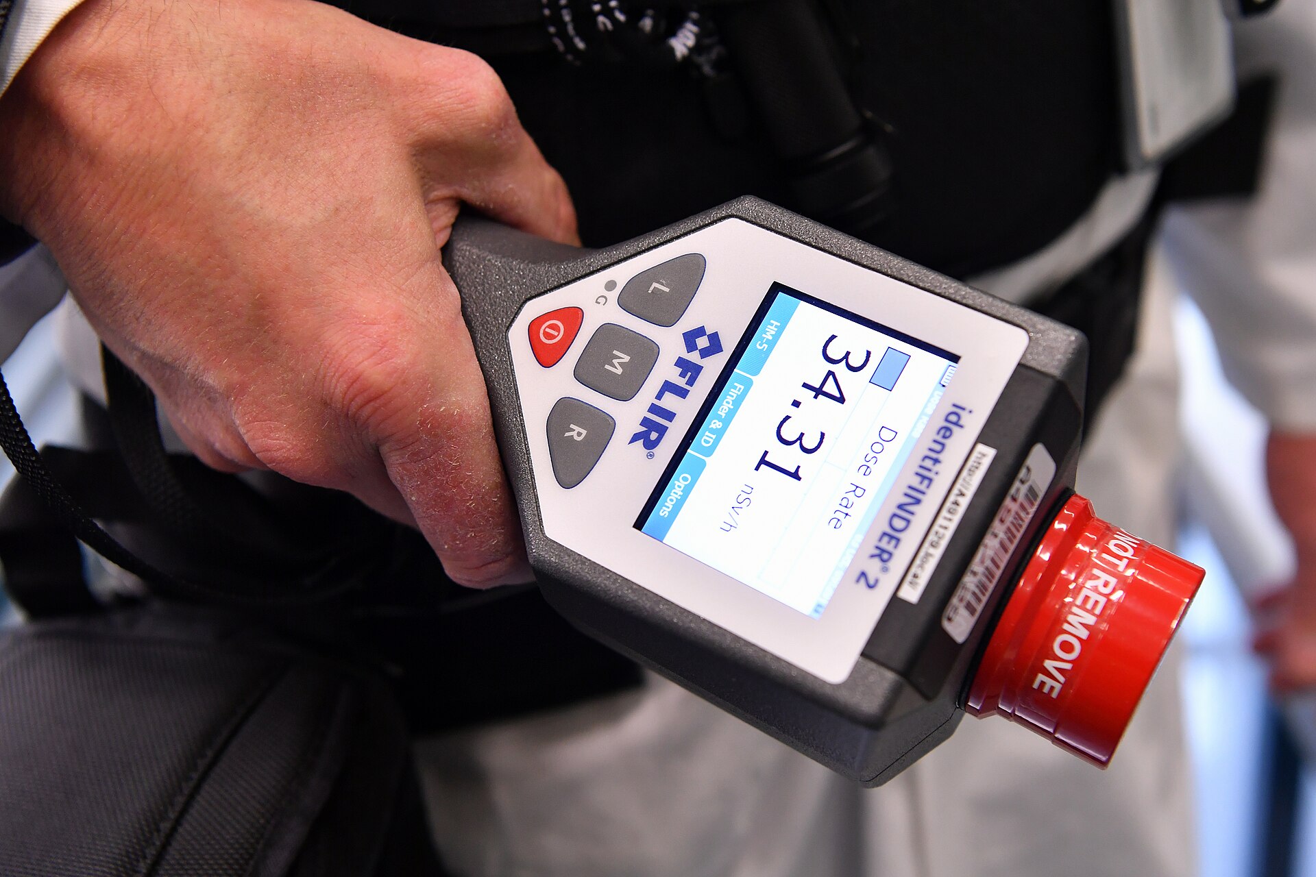 IAEA safeguards inspector holds an HM-5 nuclear measurement instrument used for verification at declared nuclear facilities