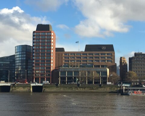 International Maritime Organization headquarters on Albert Embankment, London, with IMO flag flying above the building