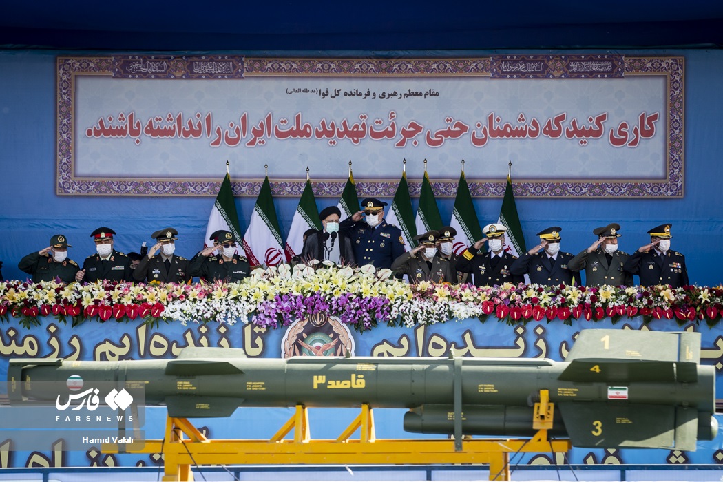 Iranian military commanders salute as a Qassed-3 missile passes on the reviewing stand at Iran National Army Day parade, Tehran 2022