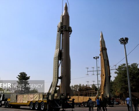 Iranian IRGC ballistic missiles on mobile erector launchers displayed at 2023 Kermanshah aerospace exhibition — Iran issued ceasefire halt order April 7 2026 while declaring war not over