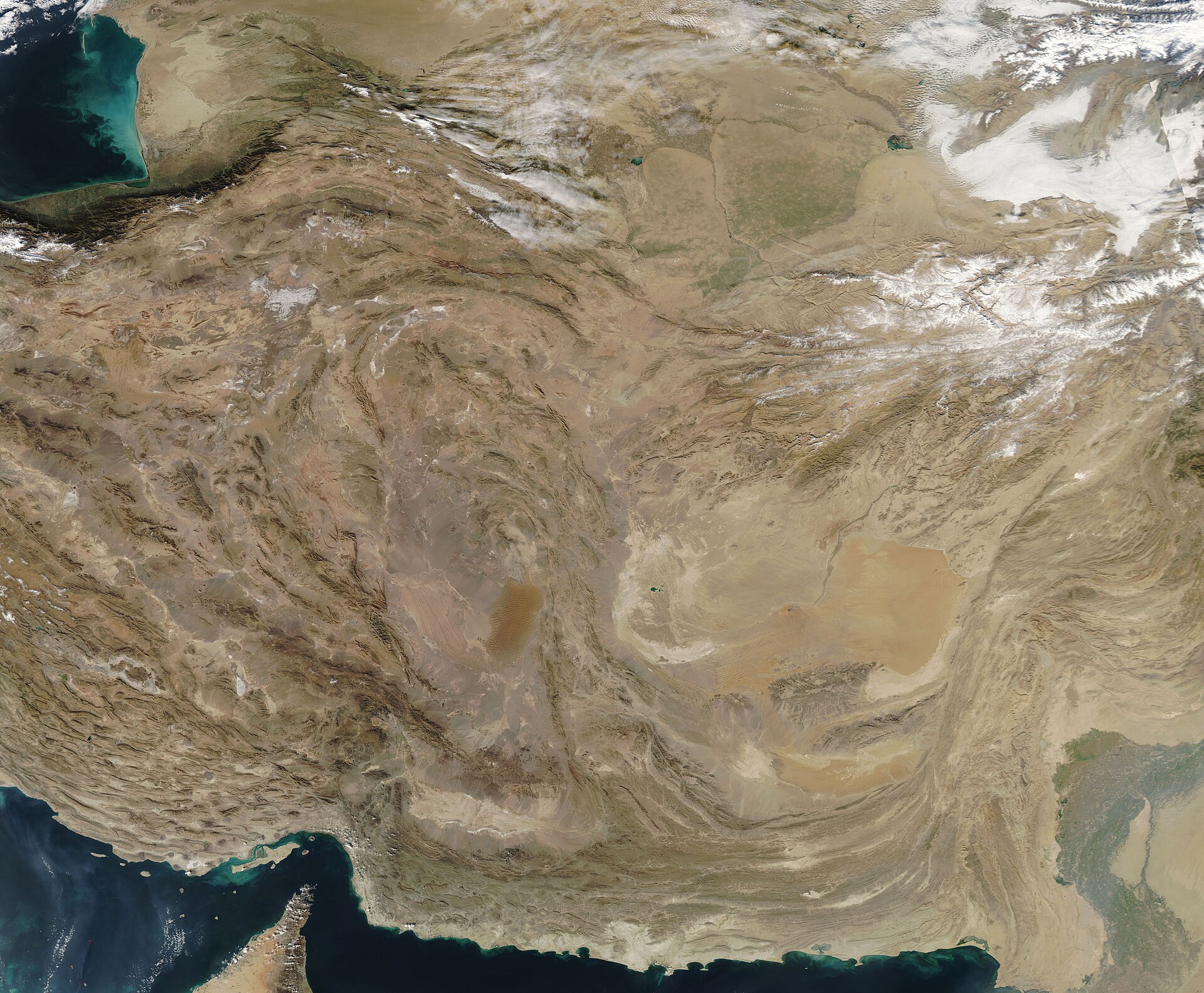 NASA MODIS satellite image of Iran, the Persian Gulf, and the Strait of Hormuz region, showing the Zagros Mountains, Iranian plateau, and surrounding countries