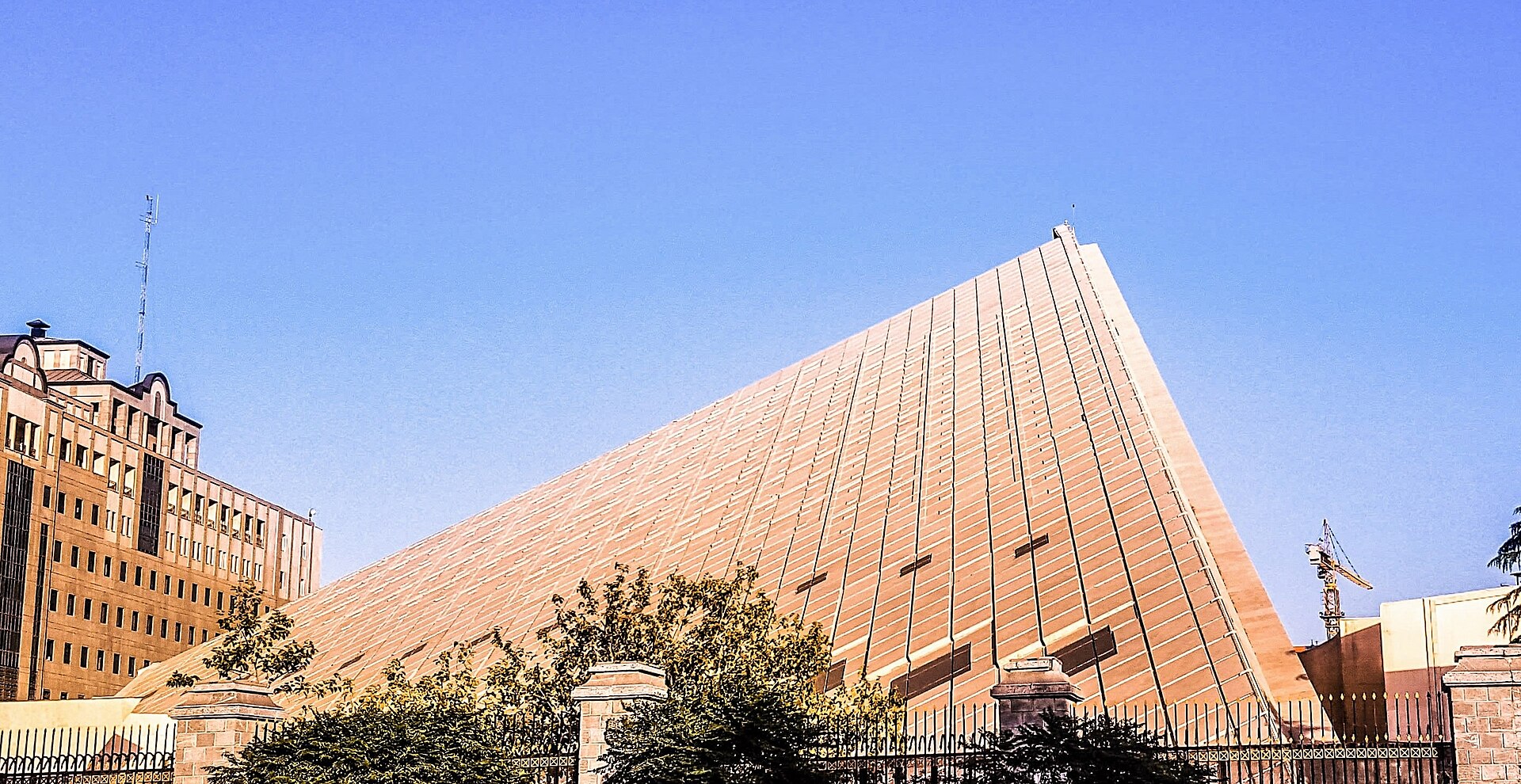The Islamic Consultative Assembly building in Tehran — the distinctive triangular facade of Iran's parliament, whose constitutional authority has been bypassed by IRGC commanders operating without a ratified Supreme Leader