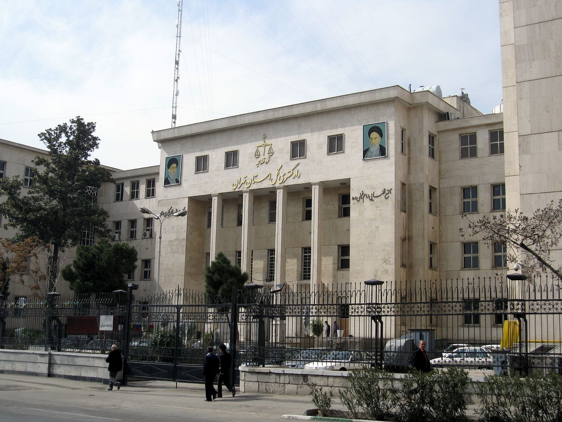 Iranian government building in Tehran displaying portraits of Supreme Leader Khomeini and Khamenei on its facade
