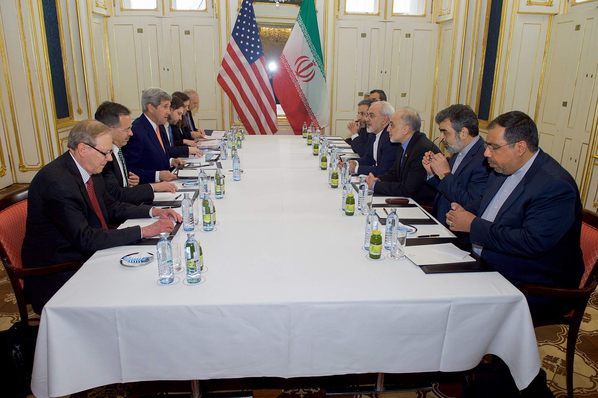 US Secretary of State John Kerry and Iranian Foreign Minister Javad Zarif face each other across the bilateral table in Vienna on January 16 2016, the day the JCPOA came into force — the same two-party format that excluded Gulf states from the room