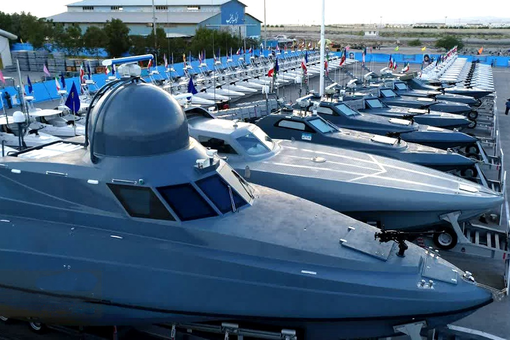 IRGC Navy missile boats and fast attack craft lined up at commissioning ceremony, March 2023 — the force that physically controls the Strait of Hormuz and has not endorsed Foreign Minister Araghchi's declaration of the strait as completely open