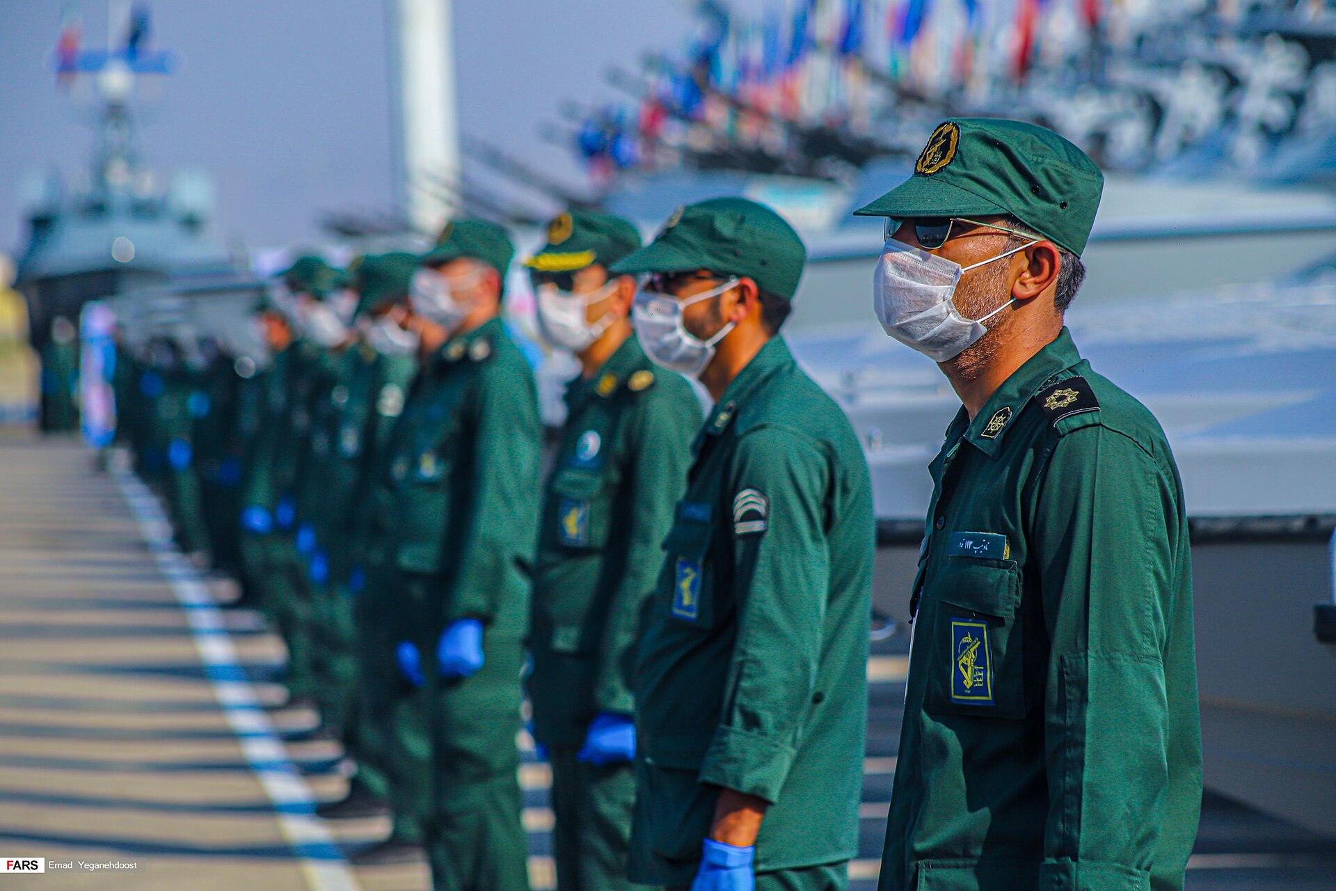 IRGC Navy personnel at the commissioning ceremony of 112 new vessels at Bandar Abbas, May 2020. IRGC fast attack craft visible in background.