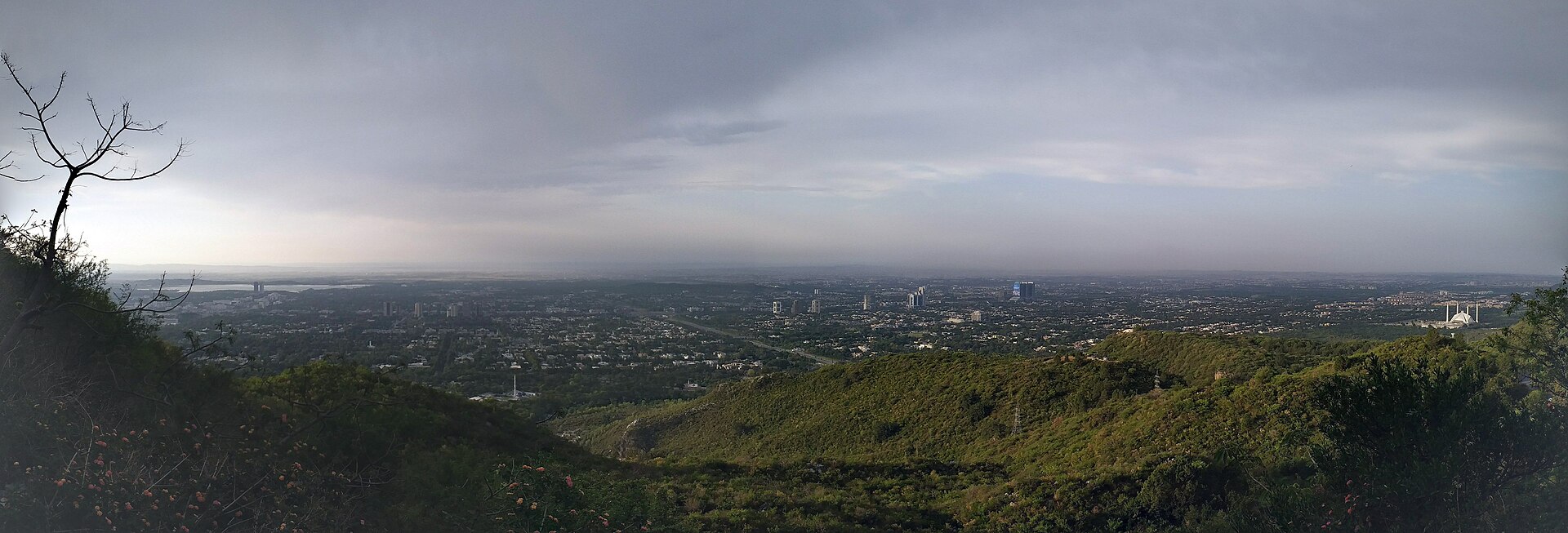 Islamabad city panorama from Margalla Hills showing government district with Faisal Mosque visible at right