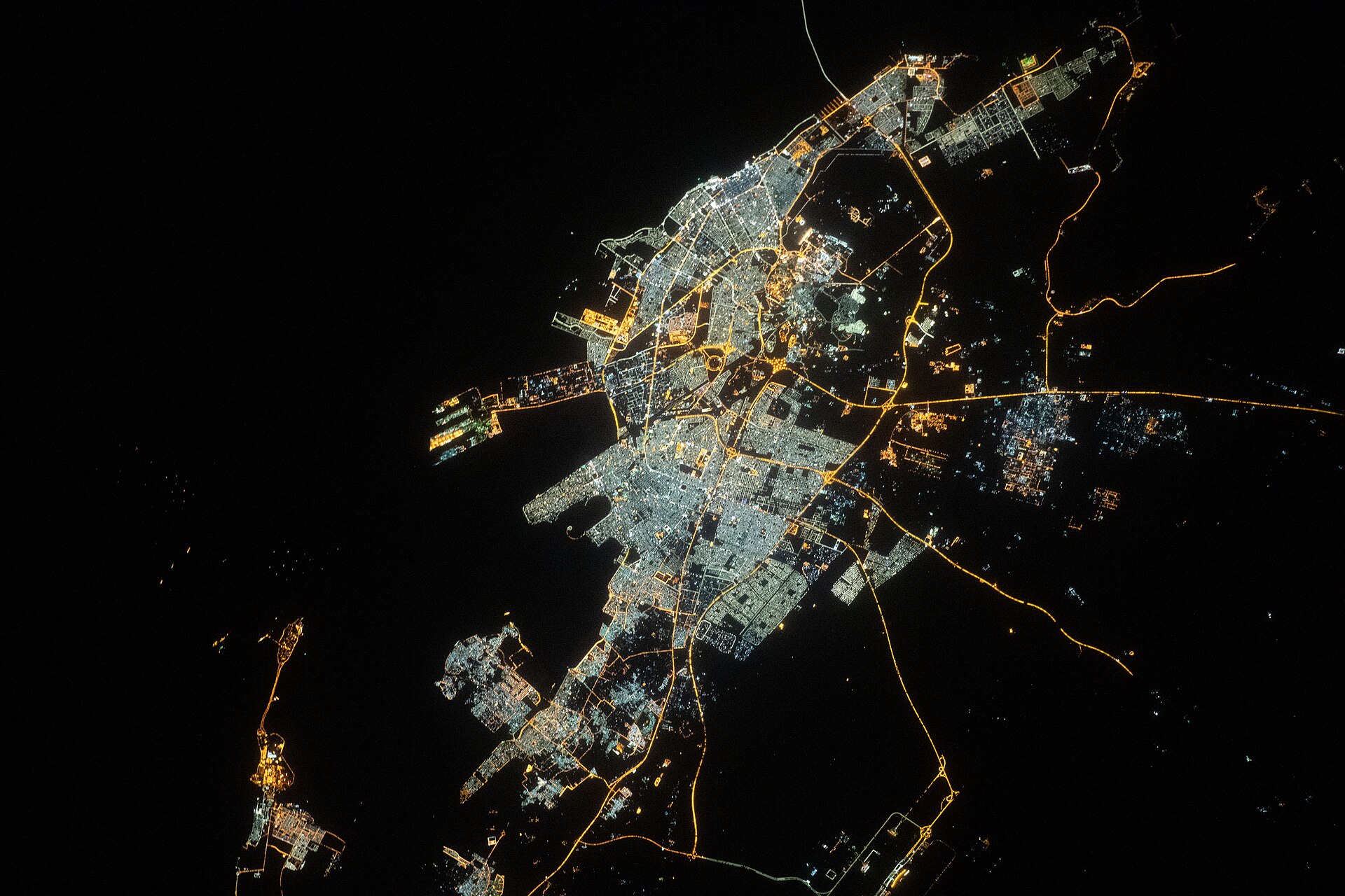 NASA ISS-62 nighttime satellite photograph of Dammam and the Eastern Province coastline of Saudi Arabia, showing the oil infrastructure corridor extending toward the Persian Gulf