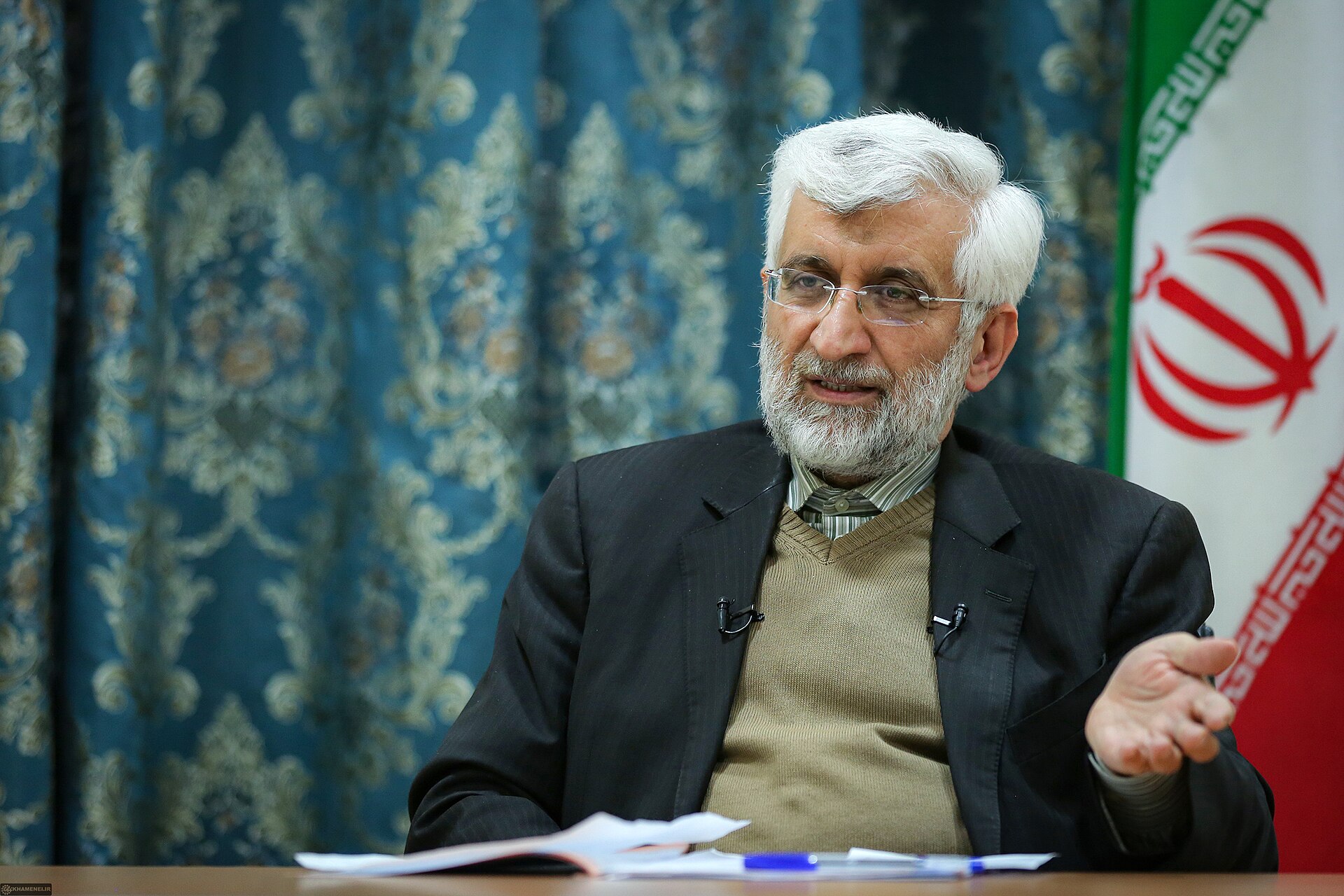 Saeed Jalili, Iran nuclear negotiator and head of the Stability Front (Paydari), speaking during a 2021 interview with the Iranian flag visible behind him