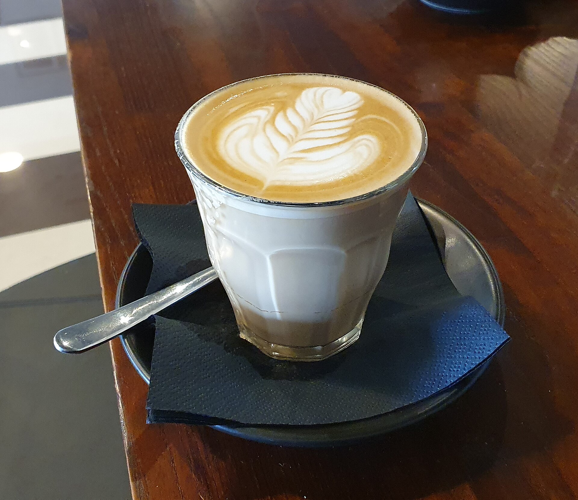 Specialty latte with art pour at a third-wave cafe in Jeddah's Al Rowdah district