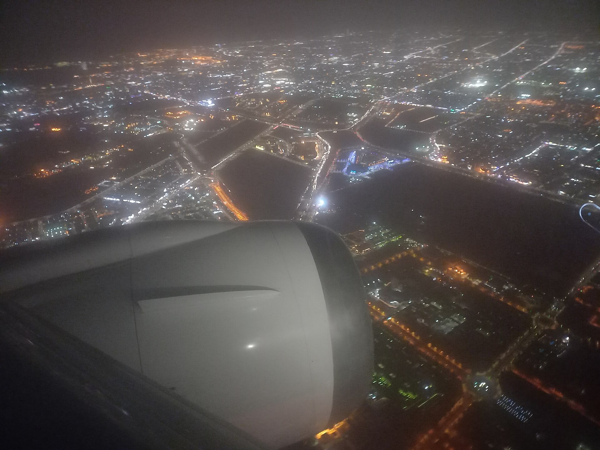 Aerial view of Jeddah city illuminated at night showing the urban grid and Red Sea coastline