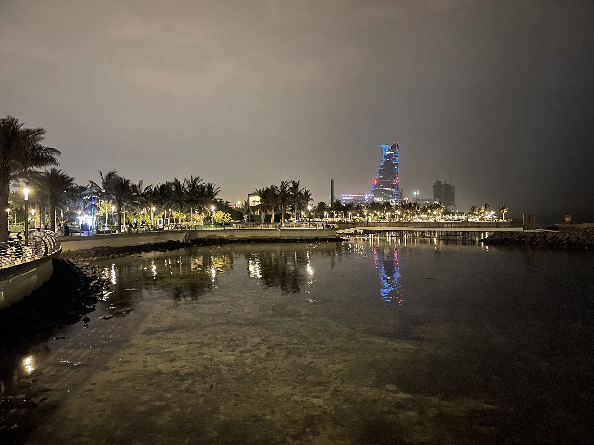 Jeddah Corniche waterfront illuminated at night with city lights reflecting on the Red Sea