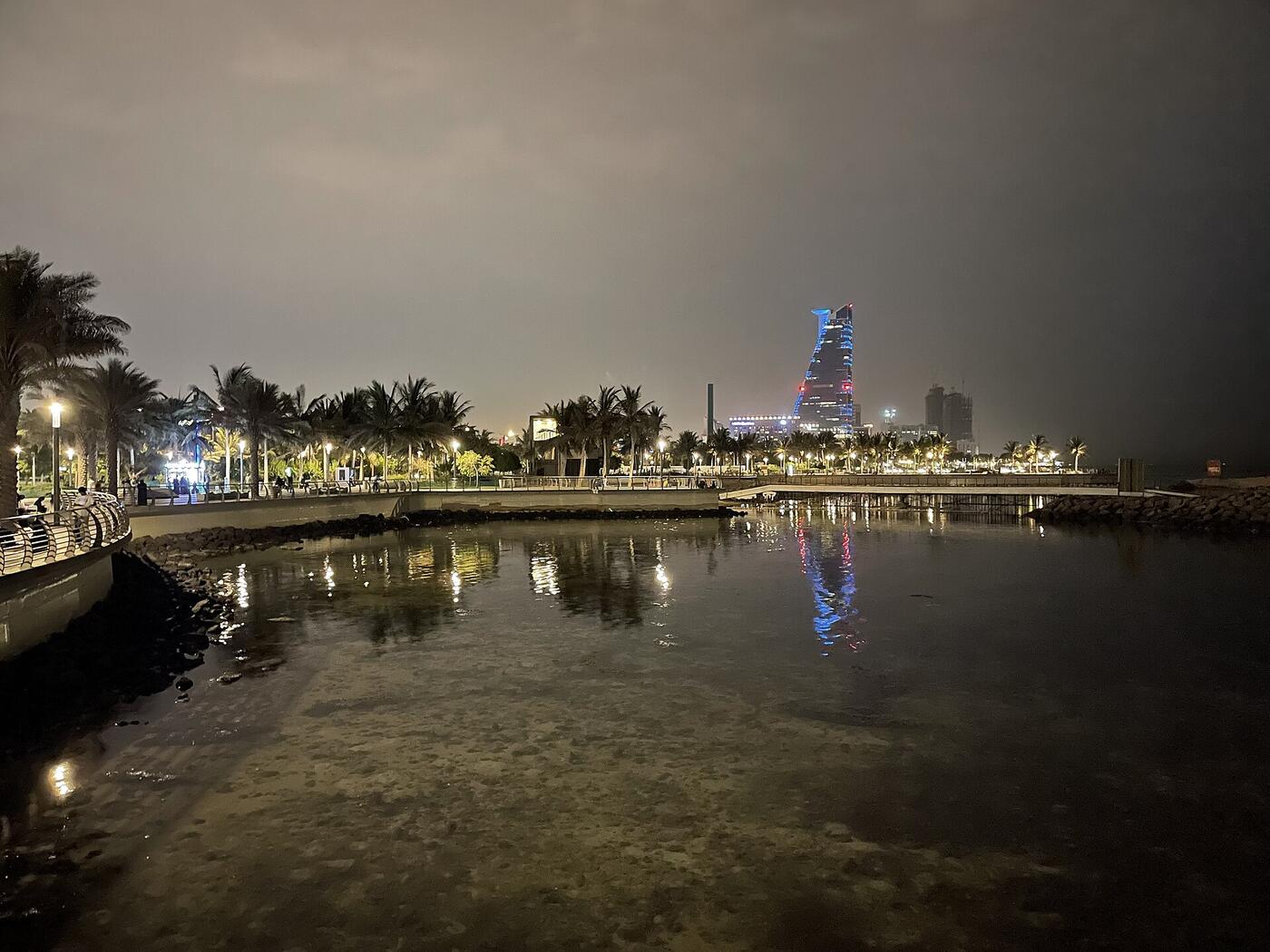 Jeddah Corniche at night with city skyline reflected over the Red Sea waterfront