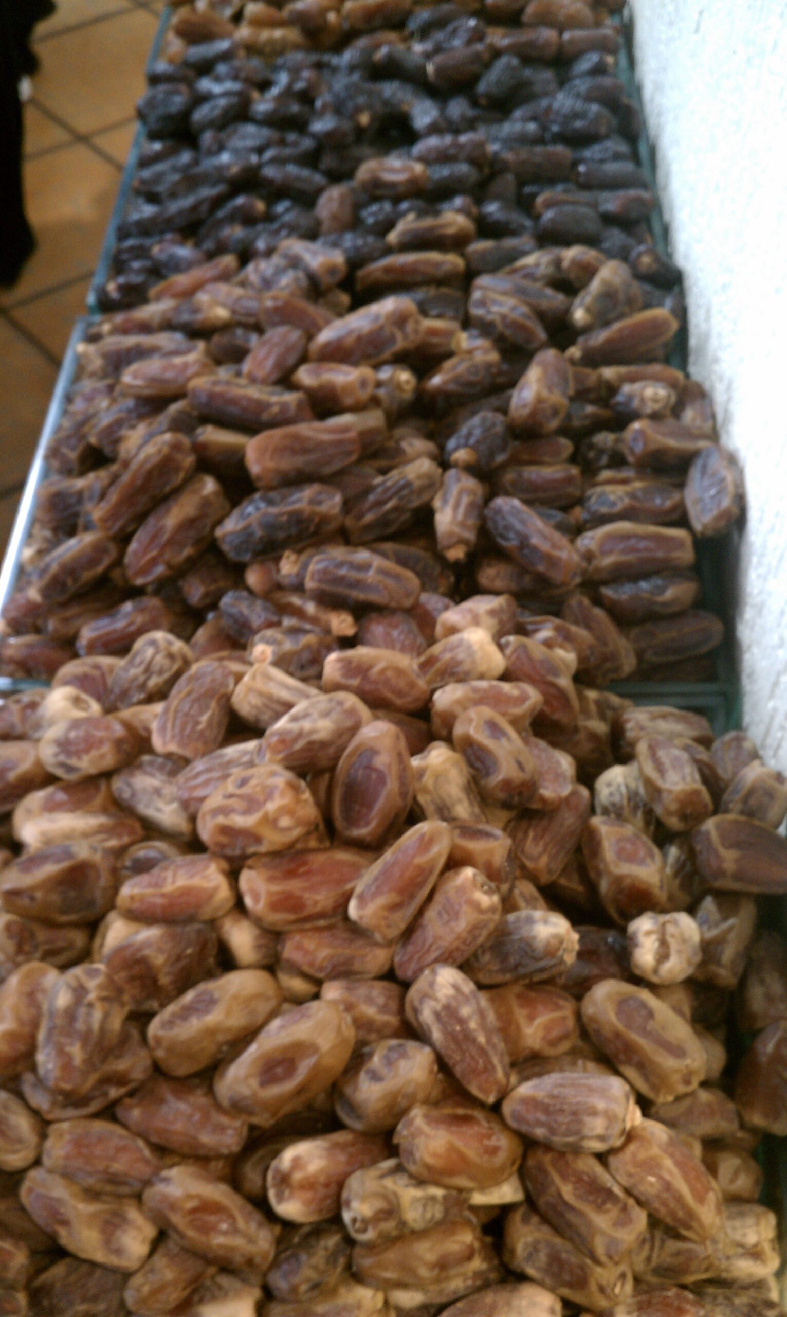 Varieties of dates displayed for sale at a traditional souk in Jeddah, Saudi Arabia