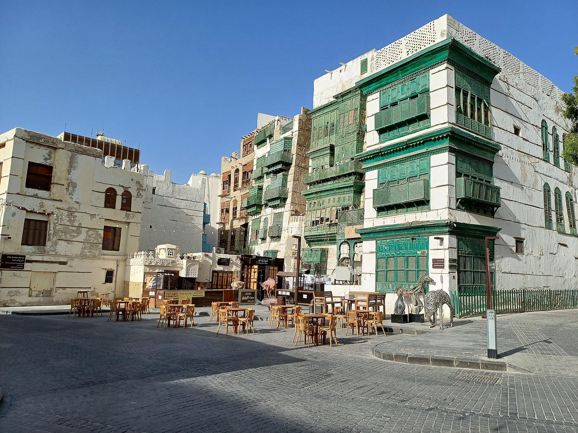 Green-painted rawasheen wooden lattice window screens on coral stone buildings in Al Balad Jeddah