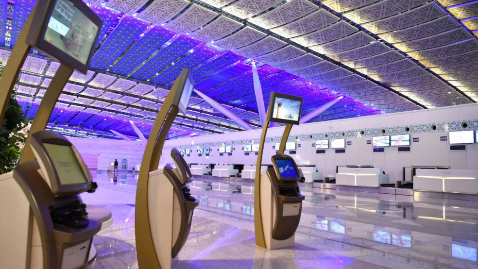Interior of King Abdulaziz International Airport Terminal 1 in Jeddah showing modern check-in kiosks and ornate ceiling