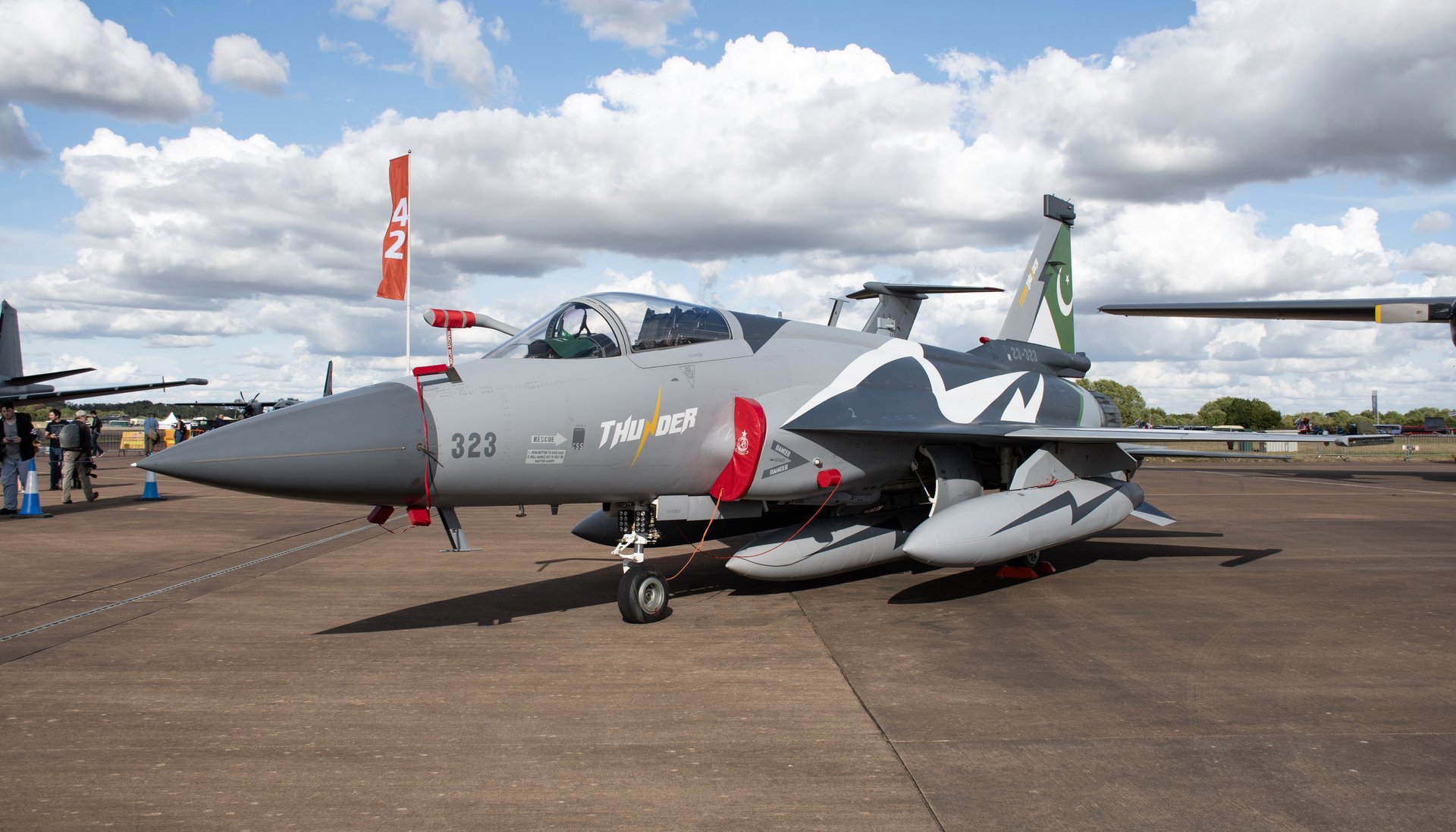 Pakistan Air Force JF-17 Thunder Block III multirole fighter jet on tarmac showing Pakistan crescent flag on tail fin