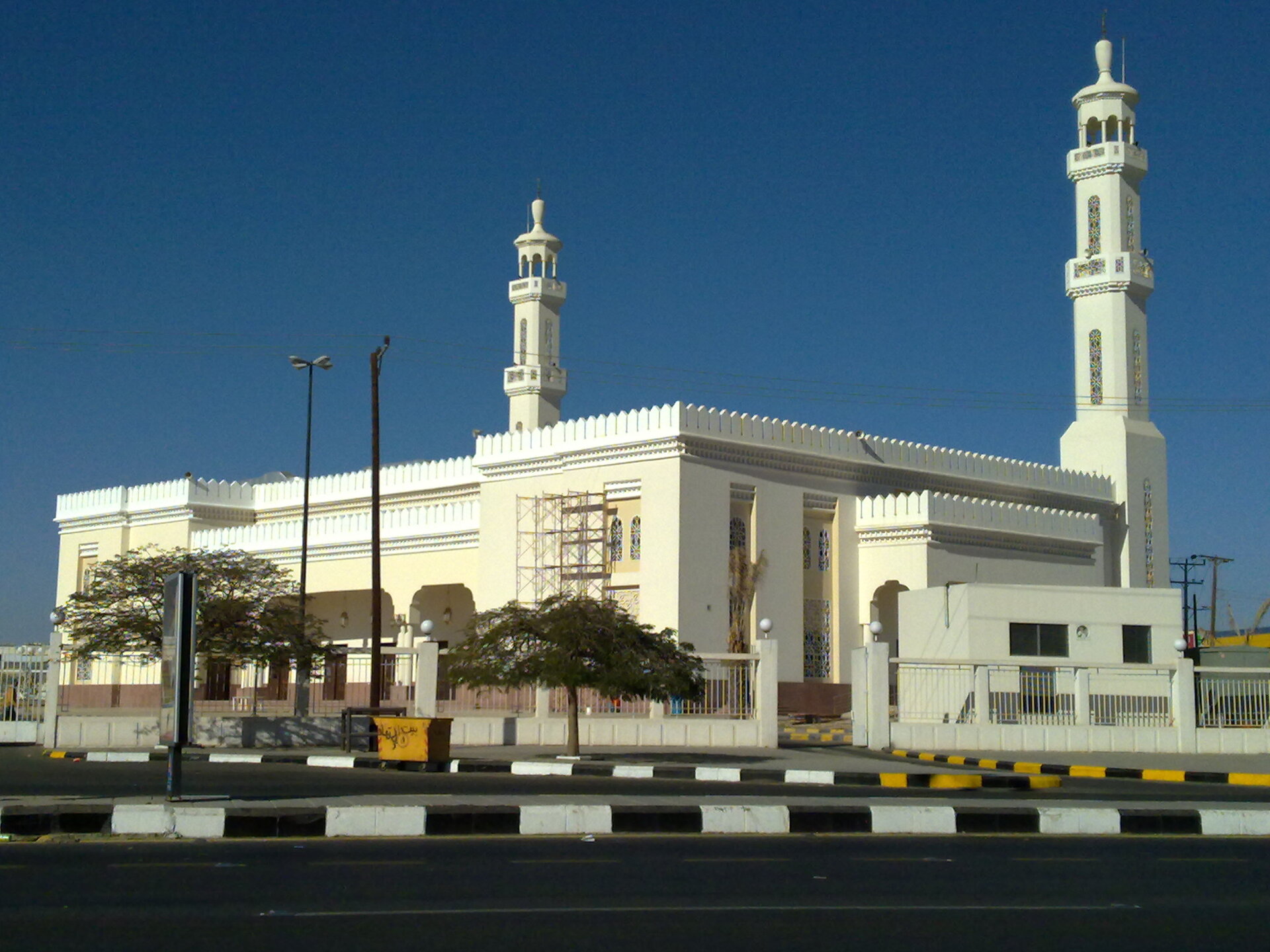 Grand mosque in Khamis Mushait with twin white minarets against a clear blue sky