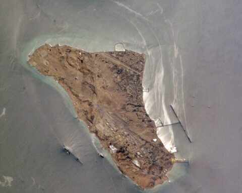 Kharg Island from orbit — Iran's primary oil export terminal in the Persian Gulf, photographed from the International Space Station. The T-shaped jetty and Sea Island Terminal are visible on the island's eastern and western flanks.