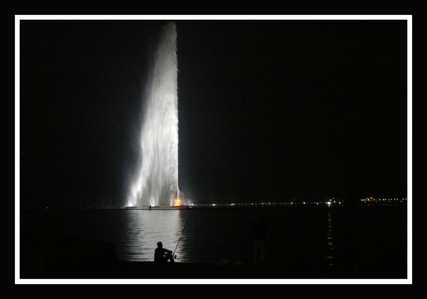 King Fahd Fountain illuminated at night shooting water 312 metres into the air over the Red Sea in Jeddah