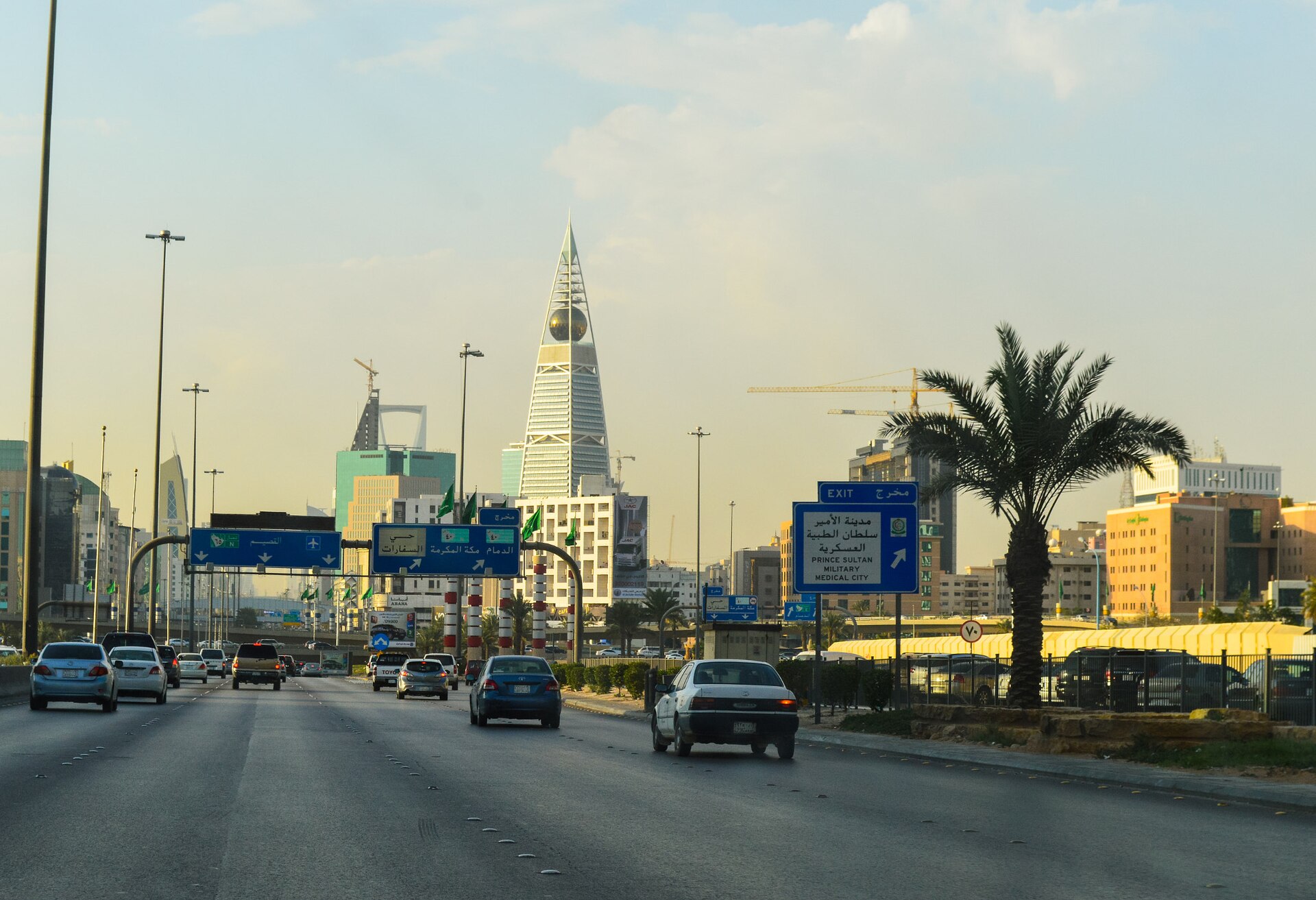 King Fahd Road in Riyadh with highway signs and the Al Faisaliyah Tower visible in the background