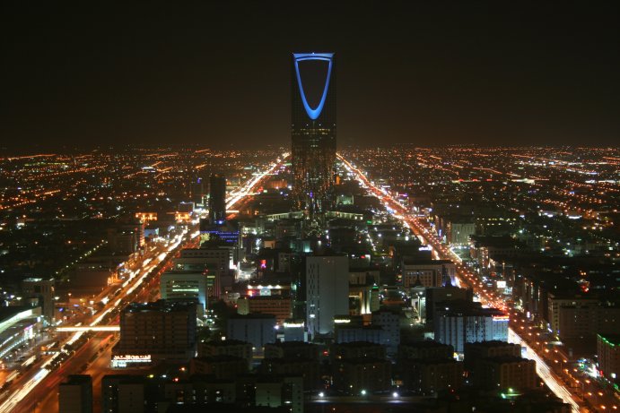 Kingdom Centre tower illuminated at night in the Riyadh skyline