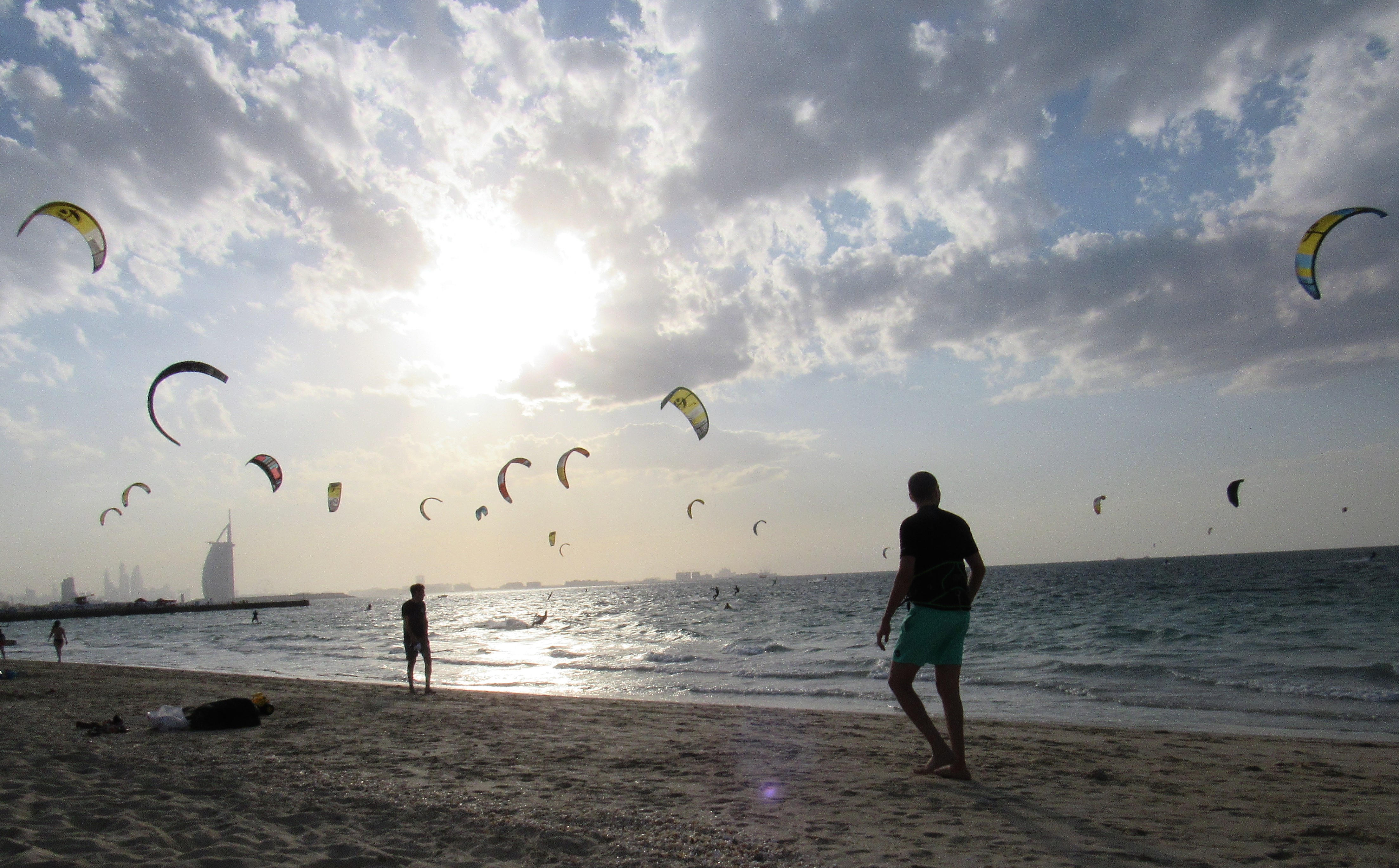 Kite surfers launching colourful kites over clear blue water near the Red Sea