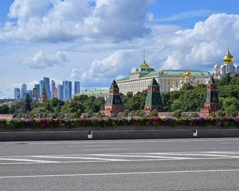 Moscow Kremlin skyline viewed from Bolshoy Moskvoretsky Bridge, showing Grand Kremlin Palace and gold-domed cathedrals, 2025