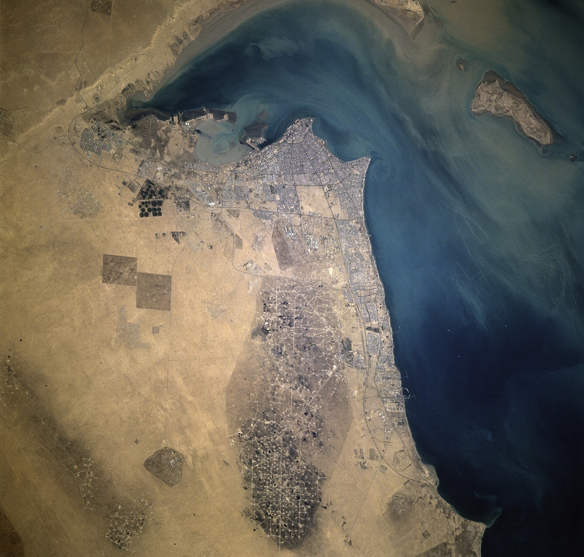 Aerial satellite view of Kuwait City and Al Burqan oil field on the Persian Gulf, showing Gulf energy infrastructure from space
