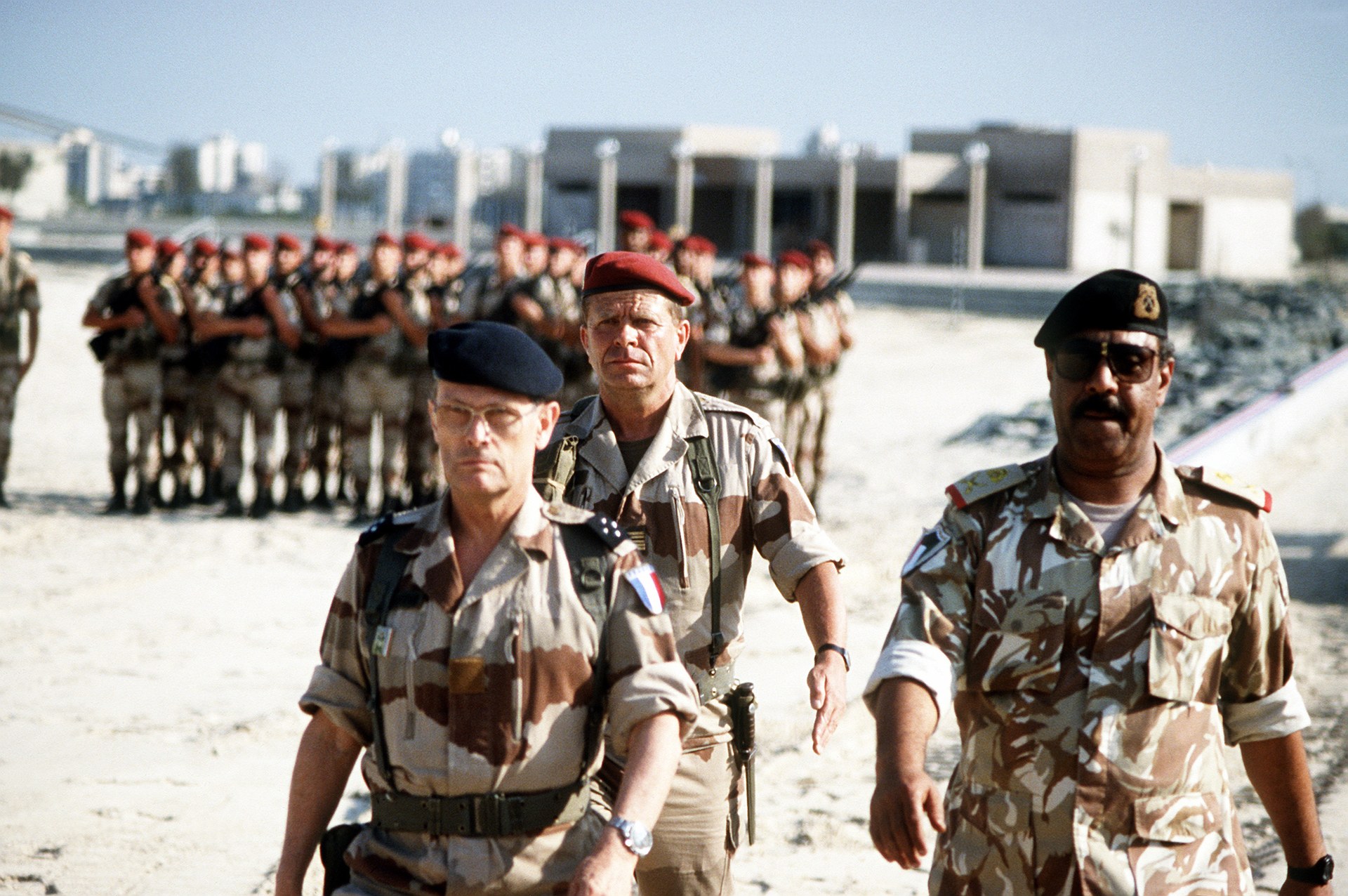 French and Kuwaiti military commanders walk with coalition forces in Kuwait during post-Desert Storm liberation ceremony, 1991
