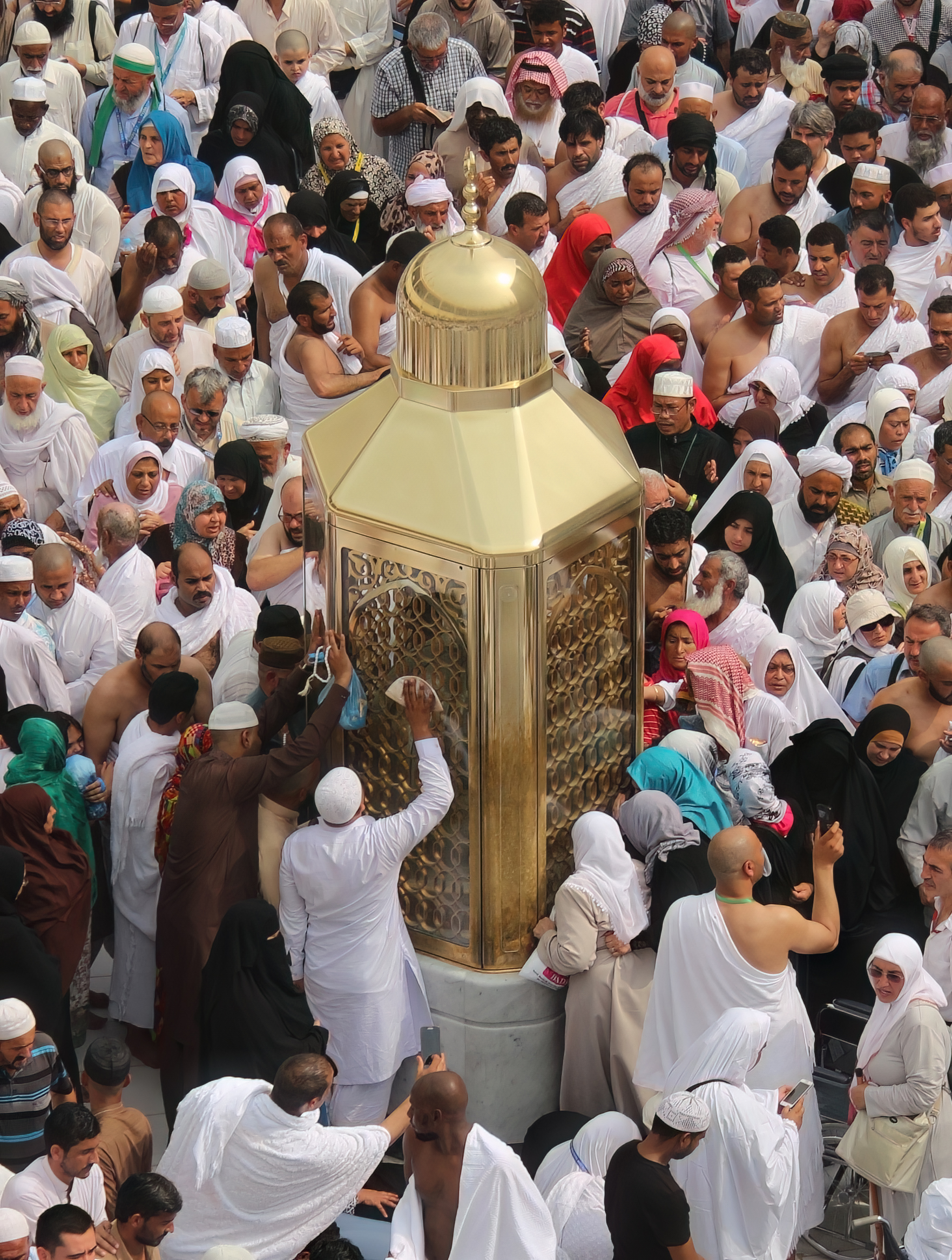 Interior of Masjid al-Haram showing marble floors, arched colonnades and worshippers in prayer