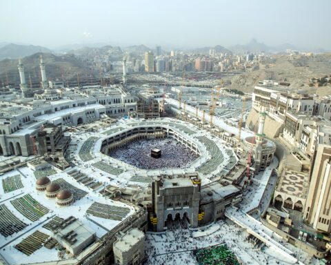 Aerial view of Masjid al-Haram, the Grand Mosque of Mecca, showing the Kaaba surrounded by tens of thousands of pilgrims during Hajj season
