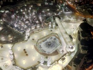 Aerial night view of Masjid al-Haram and the Kaaba, Mecca, with pilgrims visible circling the holy site