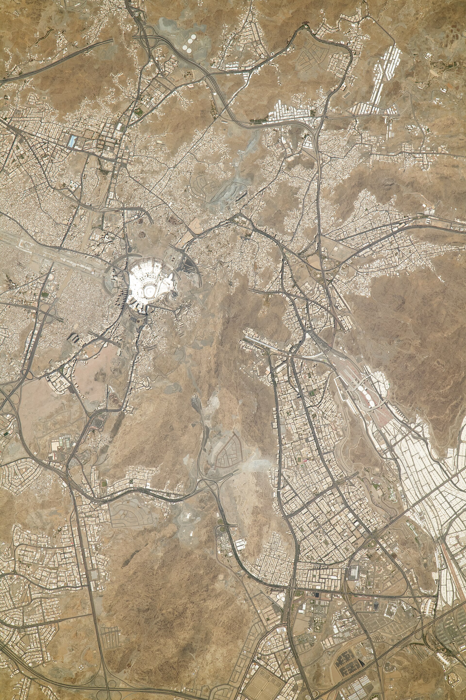 ISS astronaut photograph of Mecca, Saudi Arabia, showing the Great Mosque of Mecca and surrounding terrain including the road network toward Mina and Arafat