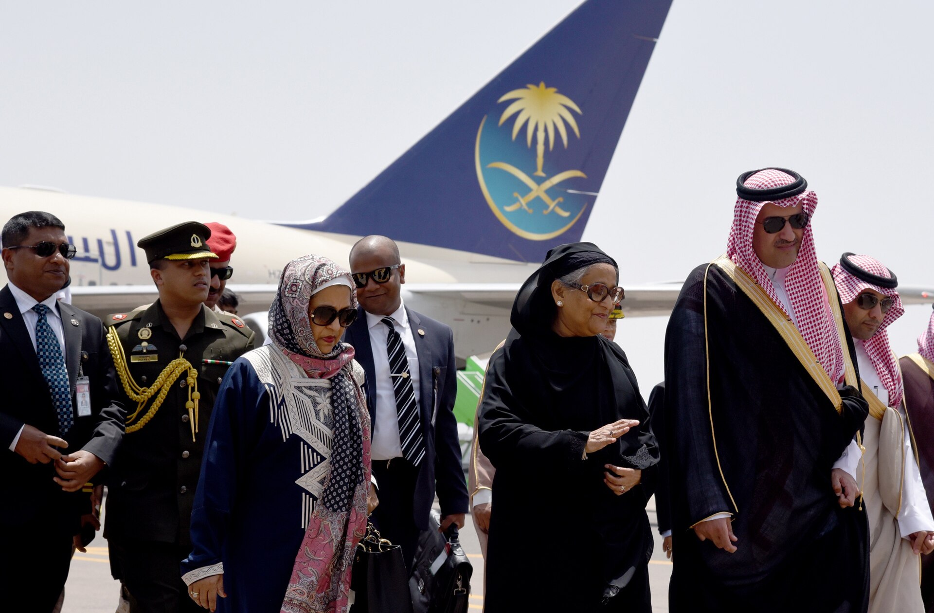 Pilgrims arriving at Prince Mohammad bin Abdulaziz International Airport in Medina, Saudi Arabia, with Saudi Airlines aircraft on the tarmac