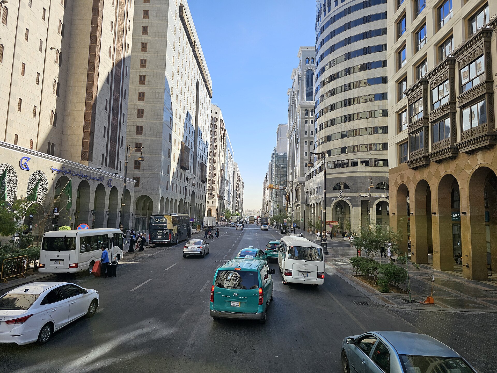 A wide boulevard lined with hotels and commercial buildings in central Medina, Saudi Arabia