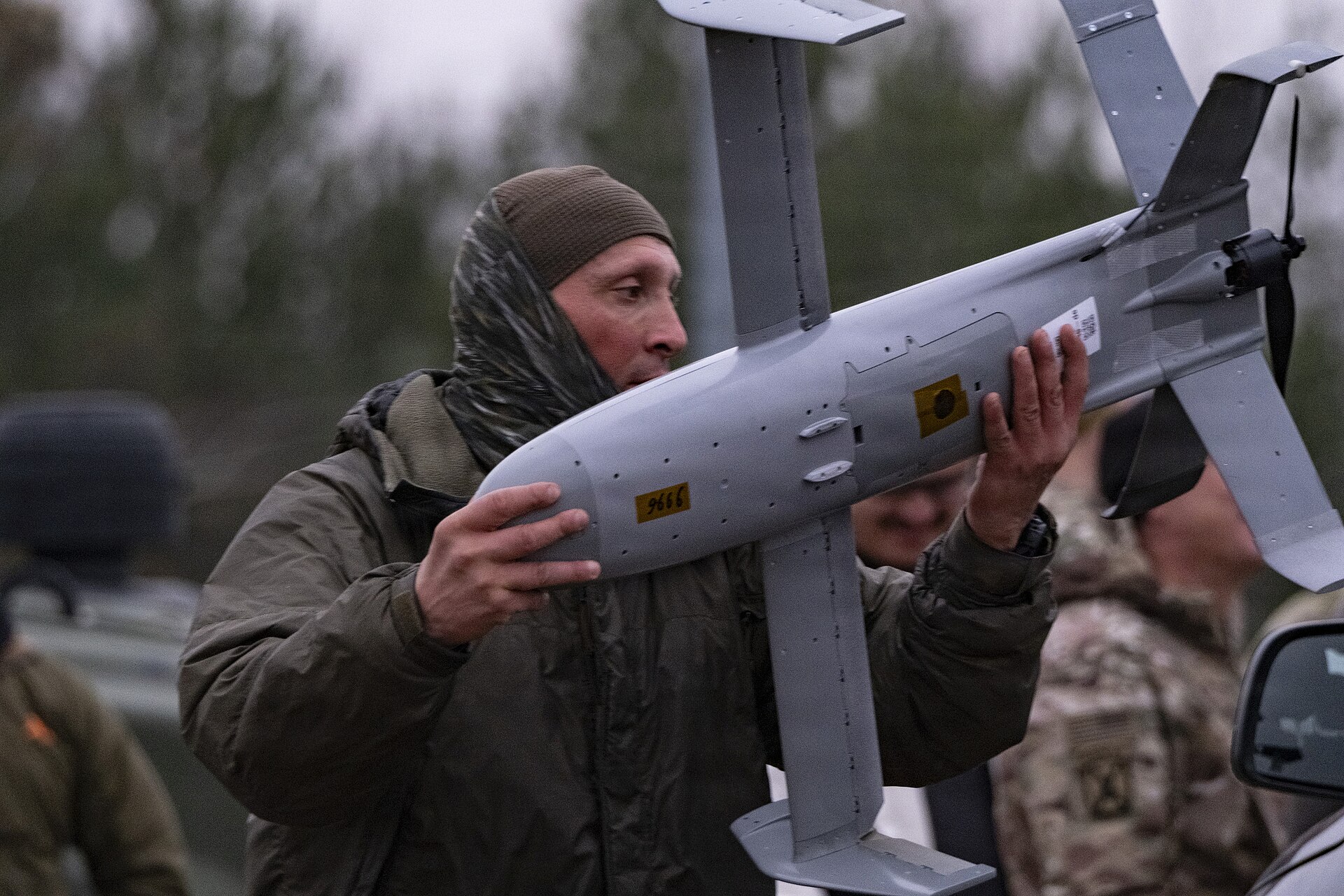 A soldier handles a Surveyor interceptor drone from Project Eagle Merops counter-UAS system during a multinational training exercise in Poland, November 2025