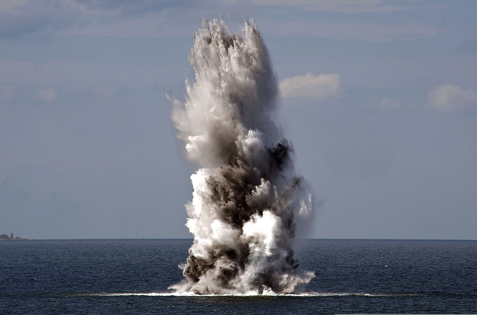 A naval mine detonates in the Baltic Sea during a minesweeping exercise as part of BALTOPS 2013, sending a column of water and smoke into the air