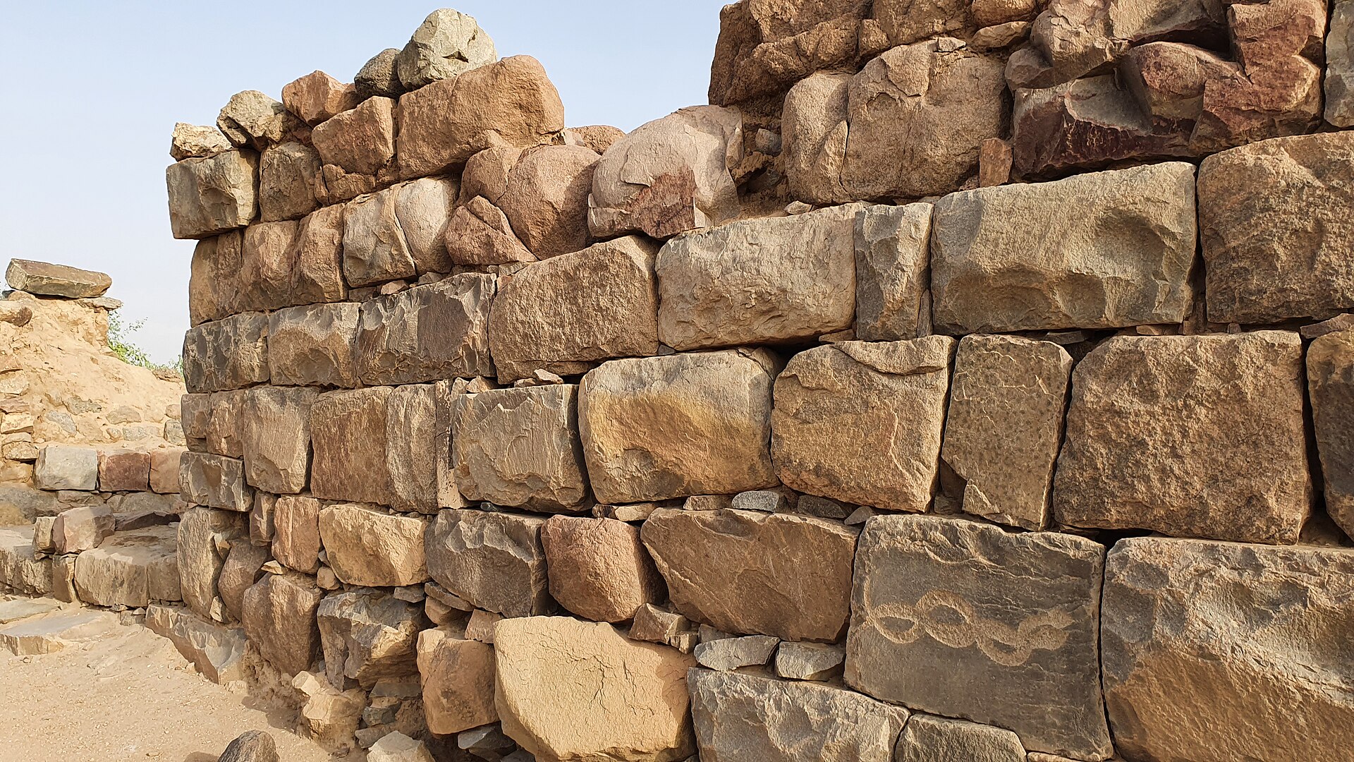 Stone ruins and excavated walls at the Al-Ukhdud archaeological site in Najran, Saudi Arabia