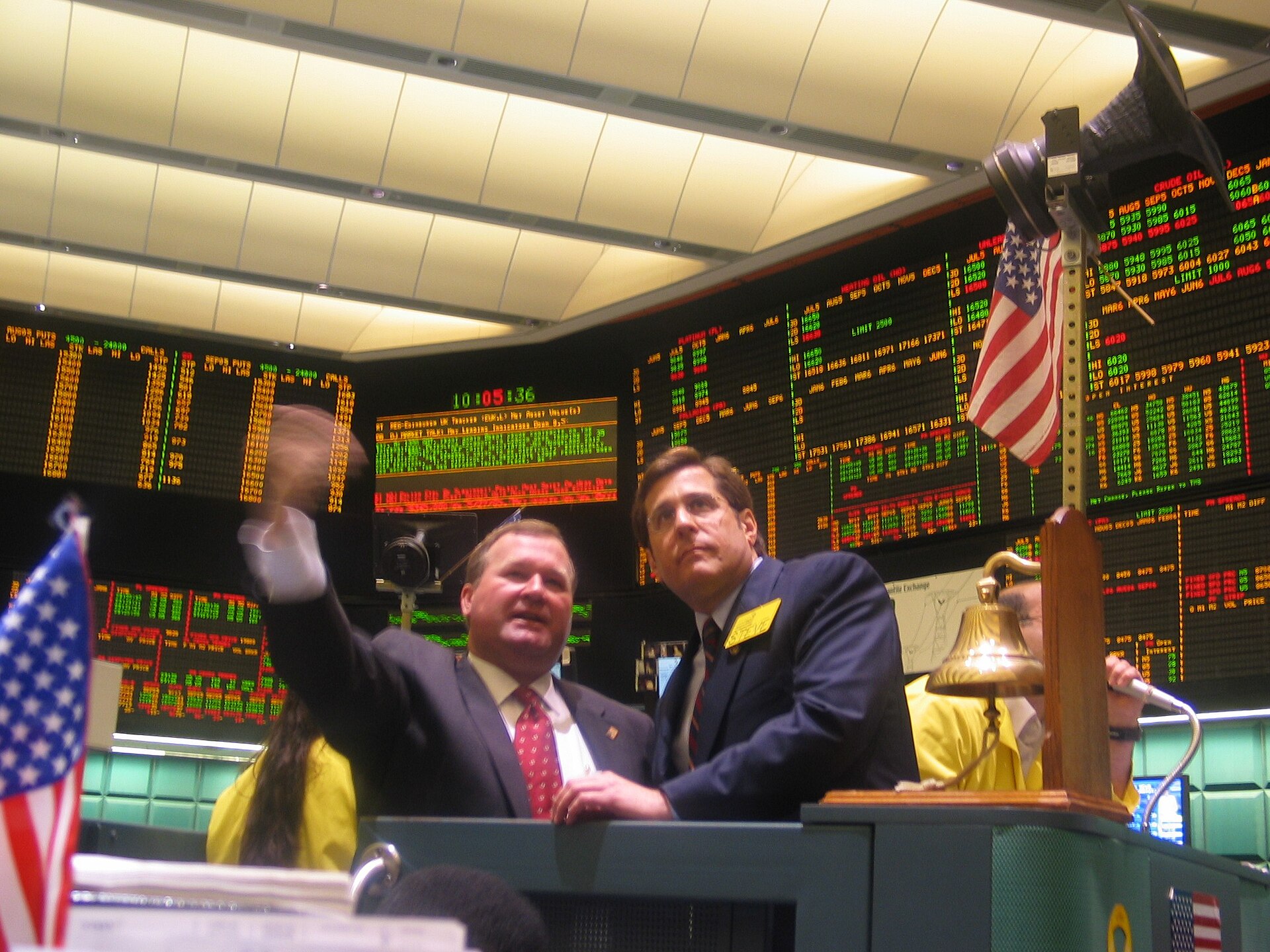 NYMEX crude oil futures trading floor with price boards showing energy contract prices in red and green