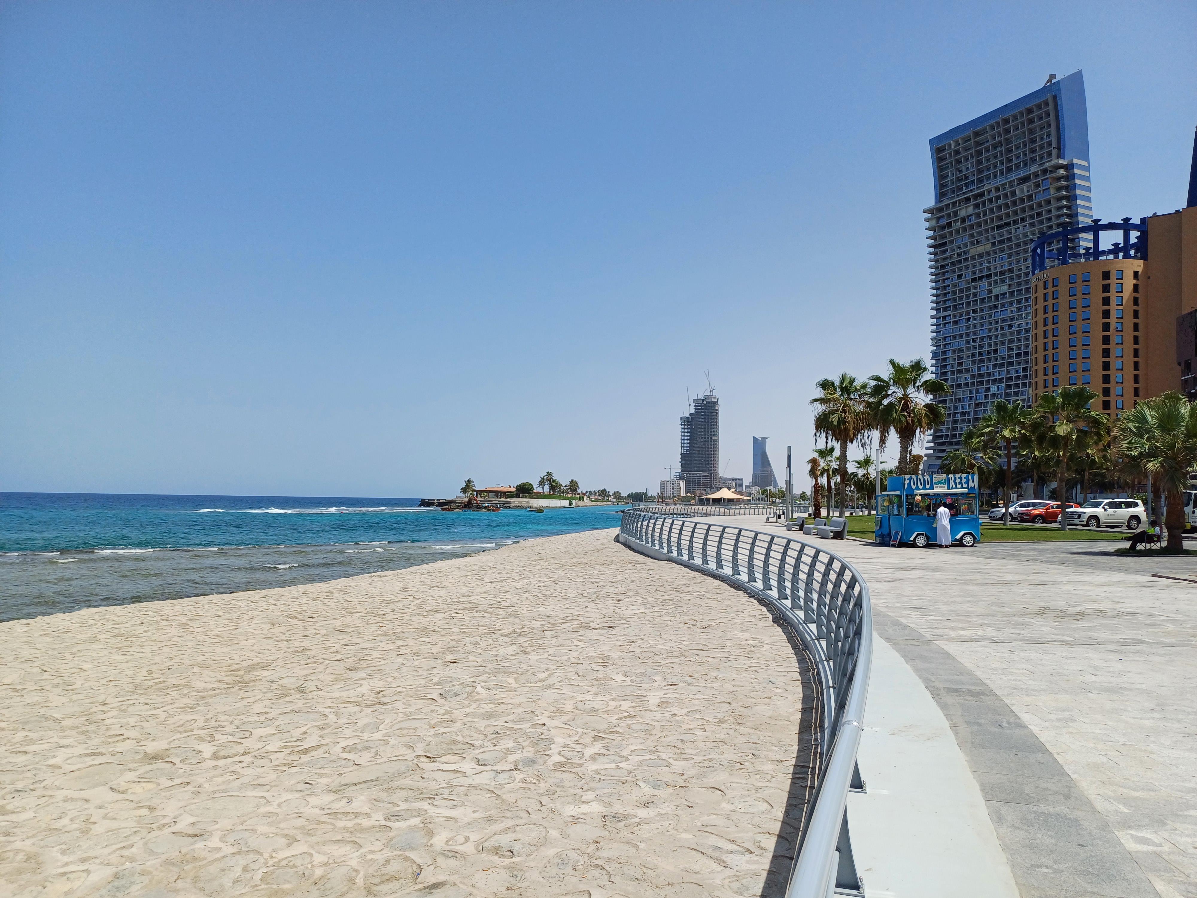 Sandy beach and modern waterfront promenade along the Jeddah Corniche with turquoise Red Sea waters