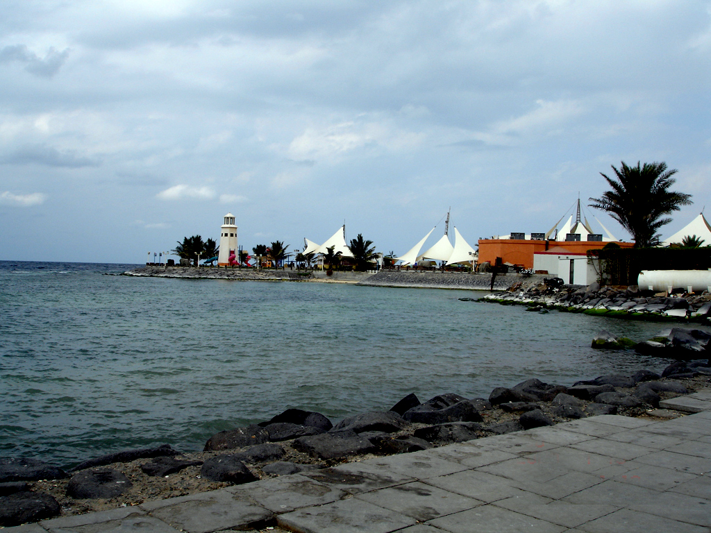 Waterfront restaurants with white tent canopies along the Jeddah Corniche at the Red Sea