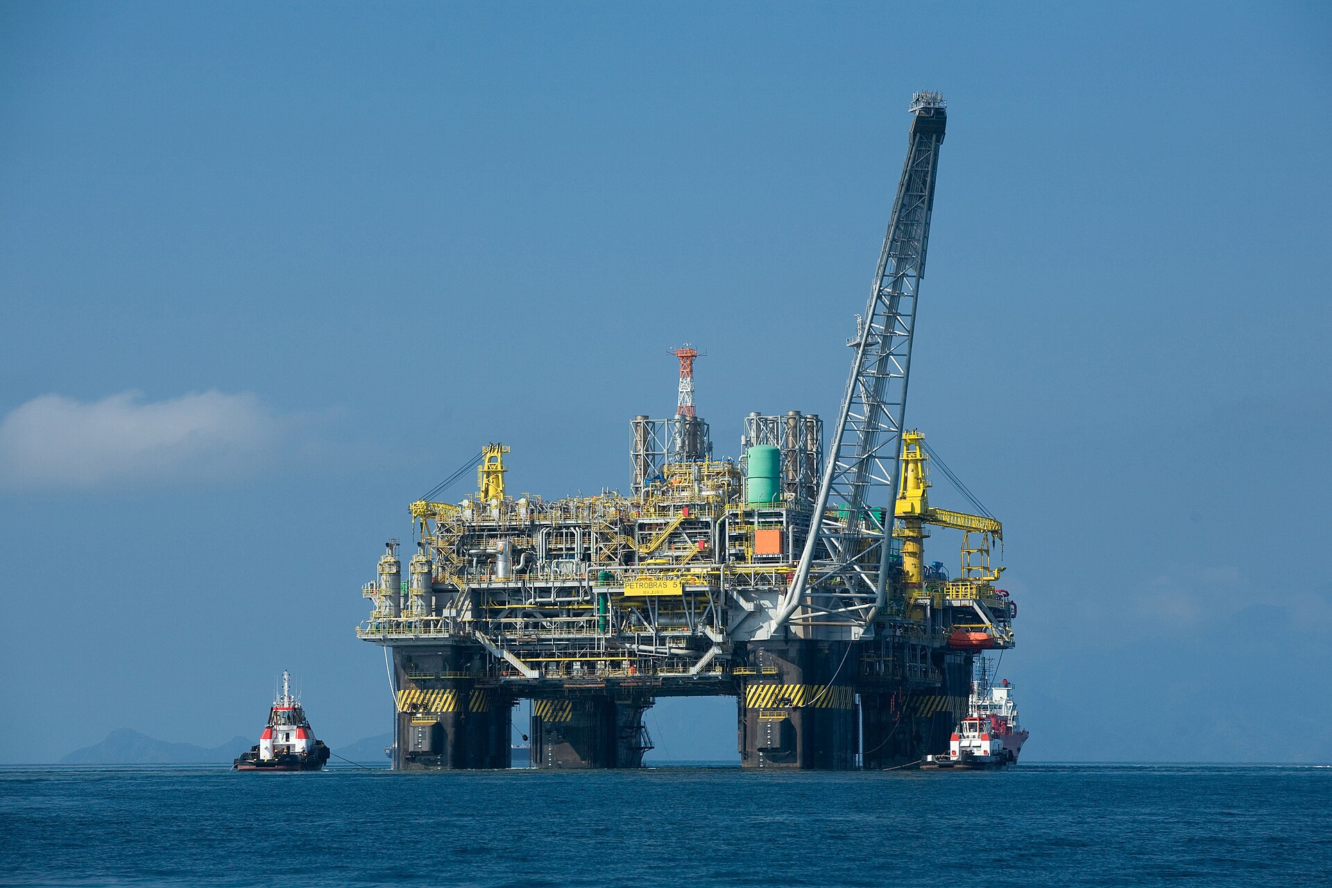 Offshore oil platform P-51 operated by Petrobras in deepwater, flanked by supply vessels