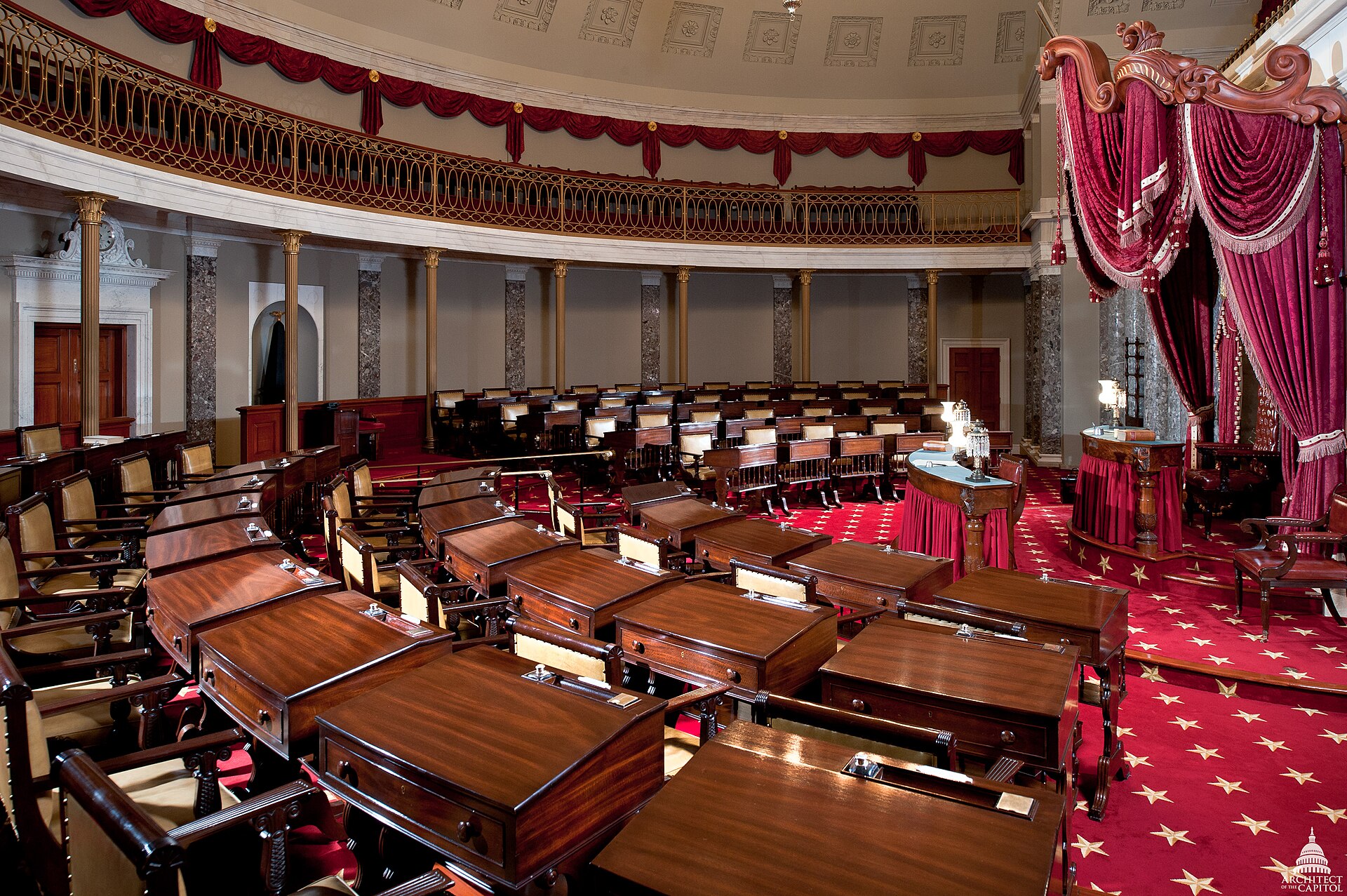 Old Senate Chamber in the US Capitol, restored interior with mahogany desks, red carpet and drapes, where the Senate met 1810-1859 during debates over war and constitutional authority