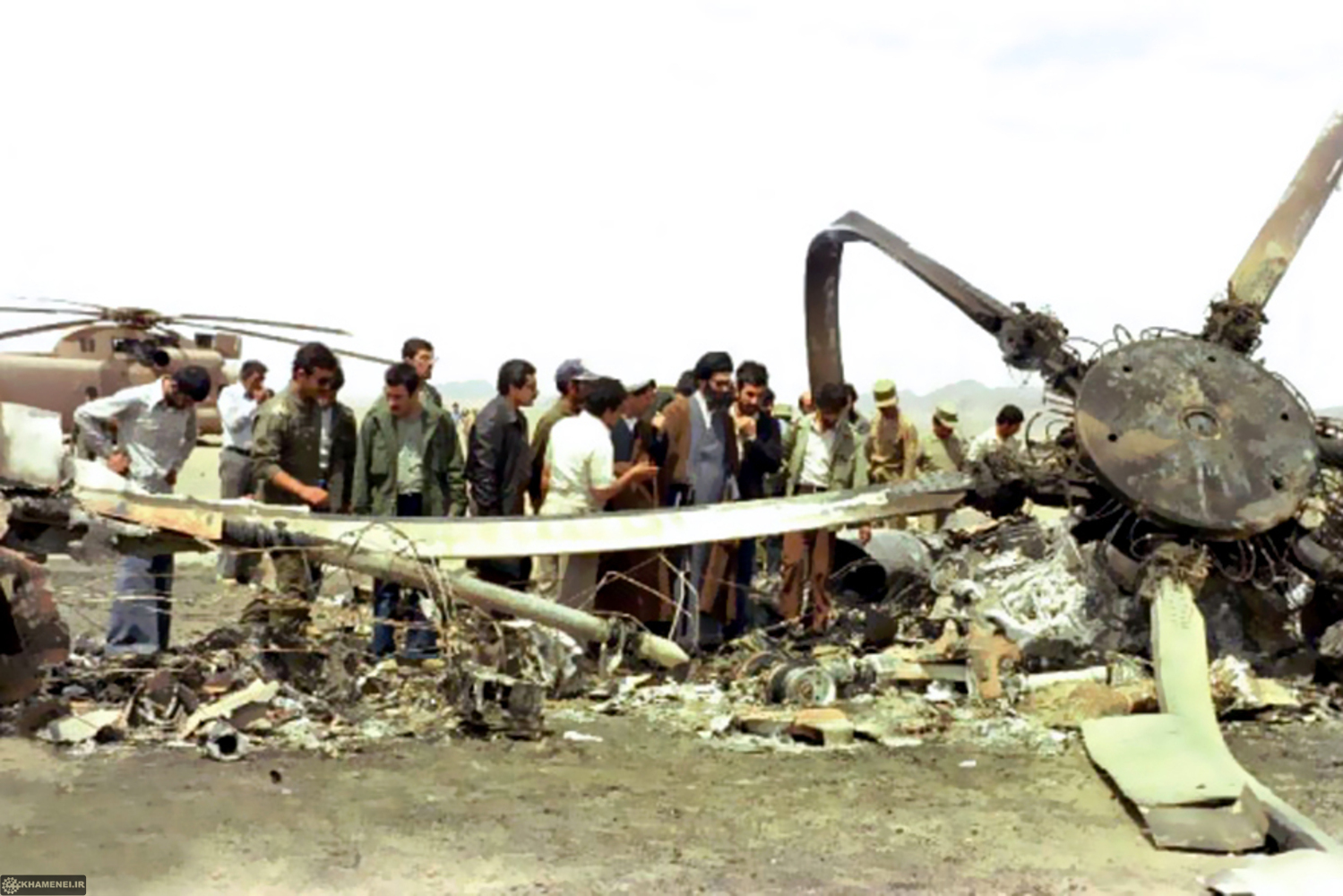 Iranian authorities inspect burned US helicopter wreckage at Tabas desert following Operation Eagle Claw, 1980