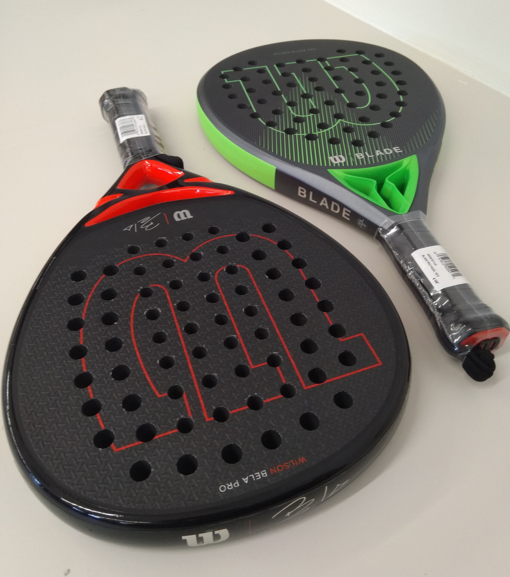 Two padel rackets showing the solid perforated face design that distinguishes them from tennis rackets