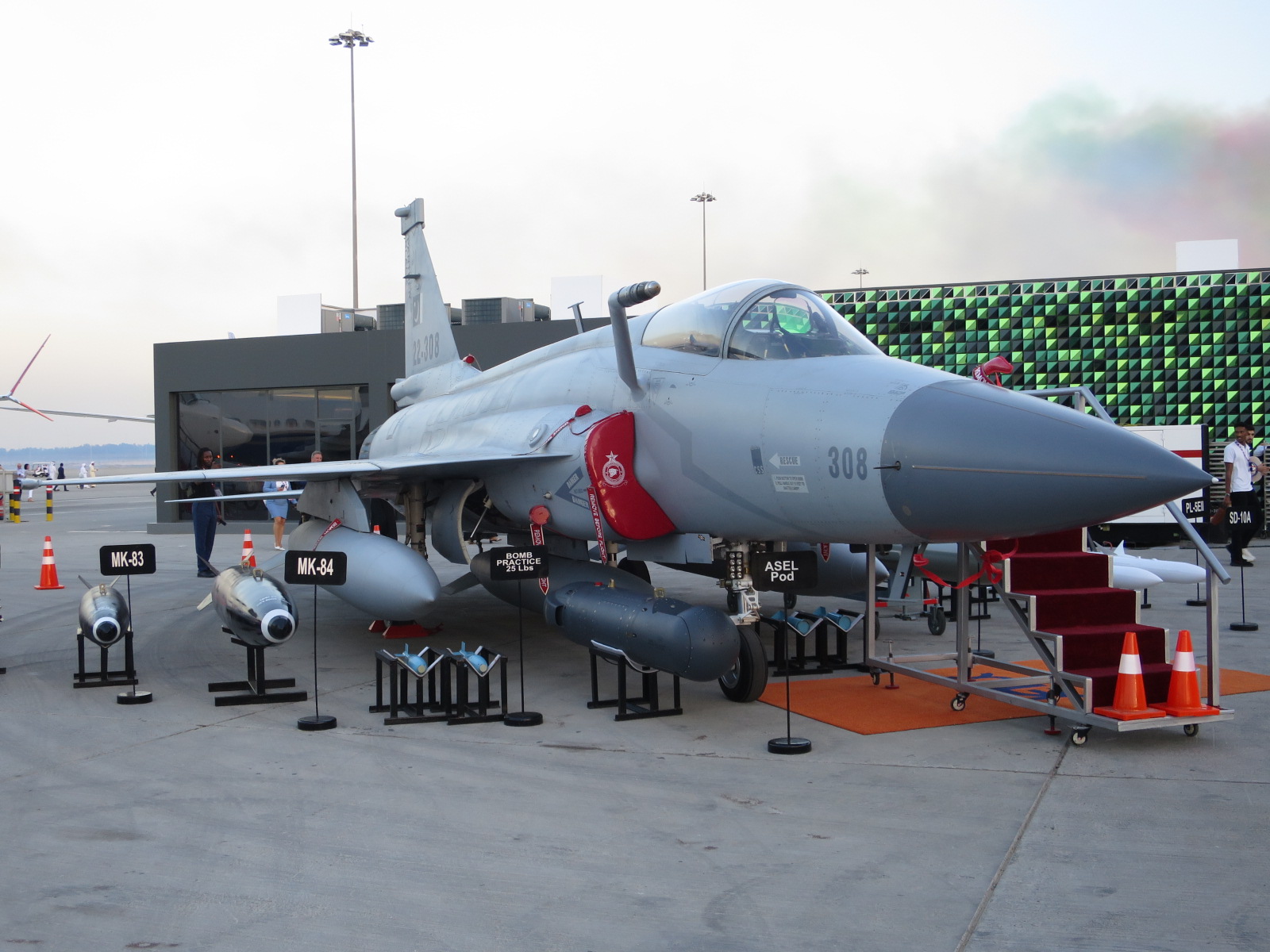 A Pakistan Air Force JF-17 Thunder Block III fighter jet on the tarmac at the Dubai Airshow 2023, serial number 308, displayed with air-to-ground munitions