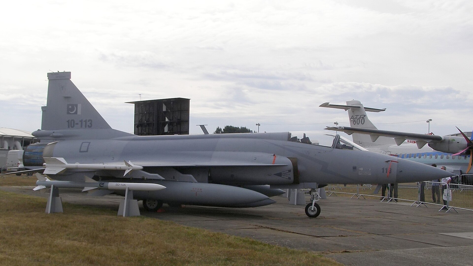 Pakistan Air Force JF-17 Thunder fighter jet on display with Pakistani crescent-and-star flag visible on tail fin